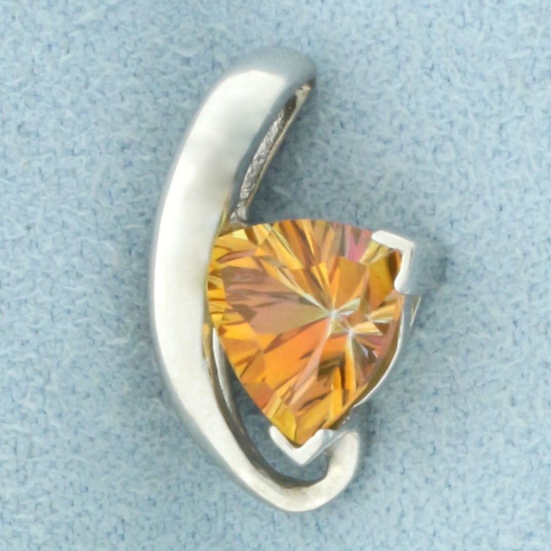 Orange Sapphire Pendant in 14k Yellow Gold: In 14k yellow gold. Contains one high quality 9mm Orange Sapphire gemstone, approximately 2.5cts, with vibrant orange color and excellent clarity. 5/8 inch long and 3/8 inch wide. 1.9g.