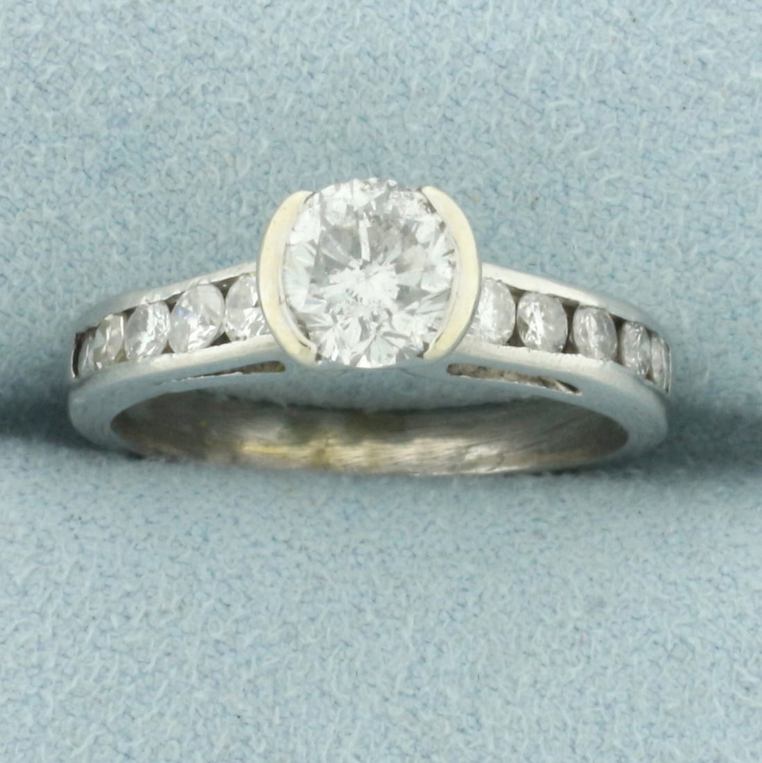 Unique Half Bezel Diamond Engagement Ring in Platinum: In platinum. Center diamond is high quality 1ct round brilliant cut diamond, H color/I clarity, eye clean, great cut for lots of sparkle. Also contains ten high quality accent diamonds, 1/2ct TW, H co