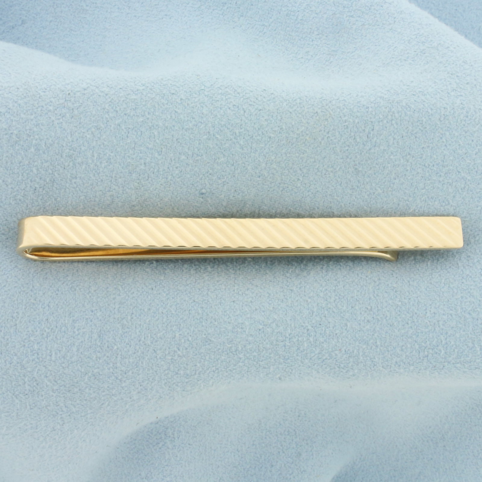 Numbered Tiffany & Co Tie Clip in 14k Yellow Gold: In 14k Yellow Gold. 2.5 inches long. 4.8mm wide. Marked "Tiffany & Co." and hand numbered "933199". Diagonal bevel design for extra reflection. 9.2g.