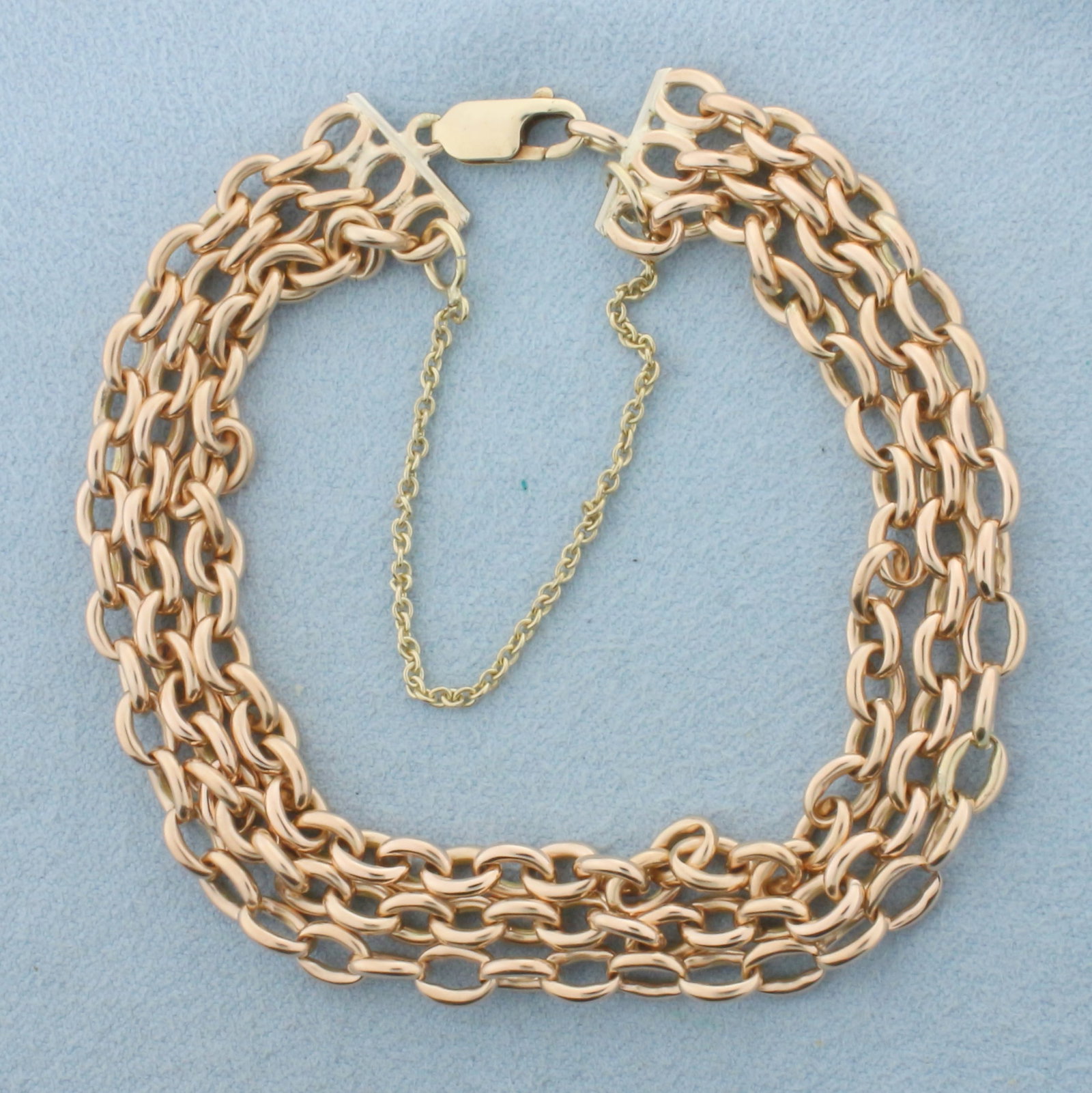 Three Layer Cable Link Chain Bracelet in 14k Rose Gold: In 14k rose gold. 7 inches long. Each strand is 4.7mm thick. Cable link. Lobster clasp with safety chain. 31.4g.