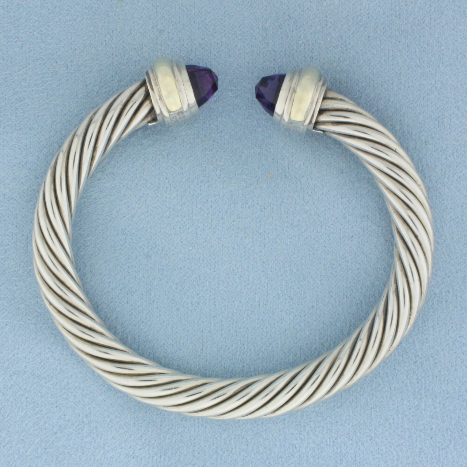 David Yurman Classic Cable Cuff Amethyst Bracelet in Sterling Silver and 14k Yellow Gold: In .925 Sterling Silver and 14k Yellow Gold. Interior dimensions: 2 1/8 inch by 1 3/4 inch. 7mm wide.