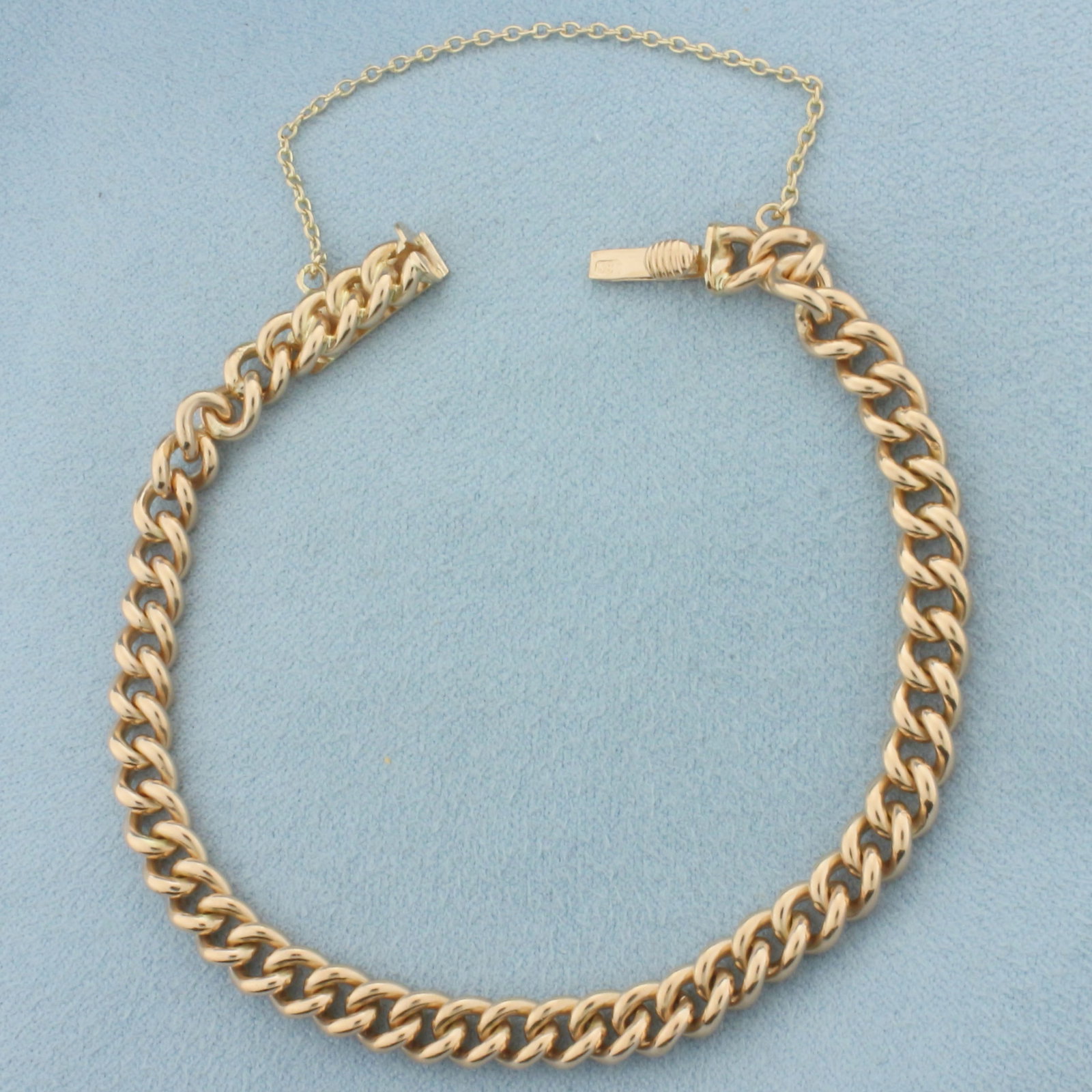 Curb Link Chain Bracelet in 14k Rose Gold: In 14k Rose Gold. 7 inches long. 5.5mm wide. Concealed slide clasp with safety chain. 17.3g.