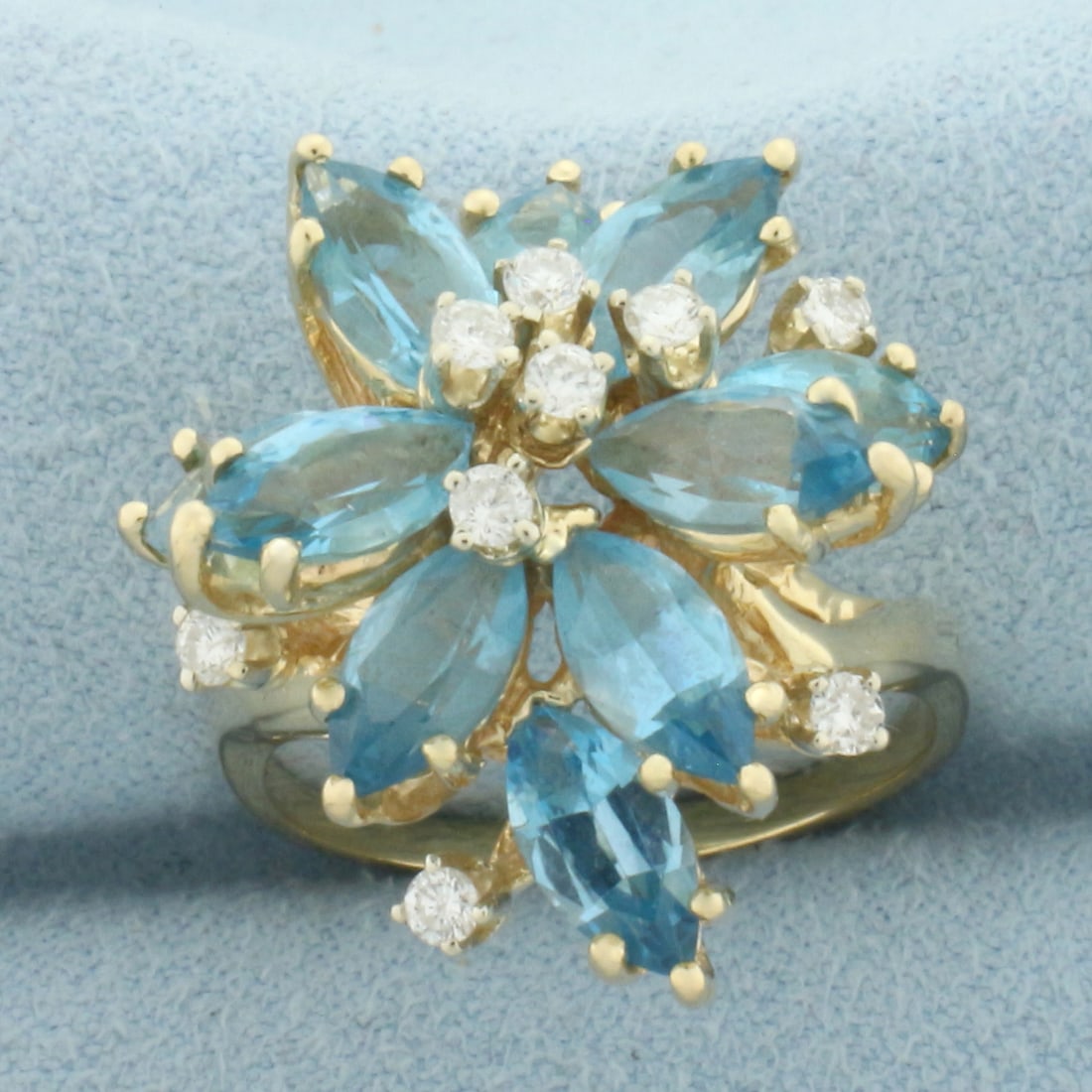 Blue Topaz and Diamond Statement Ring in 14k Yellow Gold: In 14k Yellow Gold. Contains ten high quality natural l7mm marquise Blue Topaz gemstones with vibrant color and excellent clarity. Also contains ten .03ct high quality diamonds, SI clarity/G color. 24