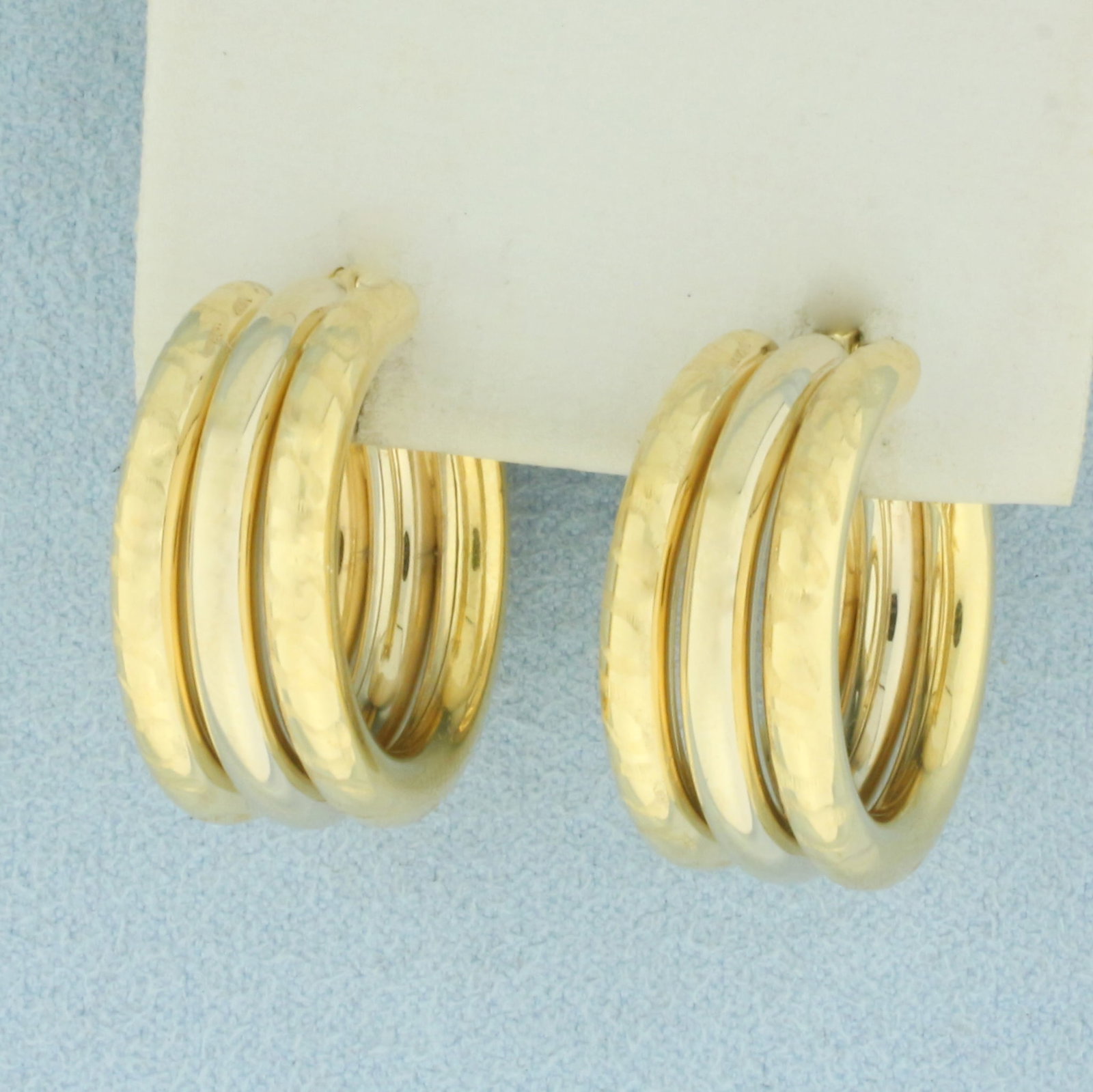 Triple Hoop Etched Design Earrings in 18k Yellow Gold: In 18k Yellow Gold. 7/8 inch diameter. Inner hoop high polish, outer hoops etched design for unique look. 3/8 inch wide. Leverback. 9.8g.