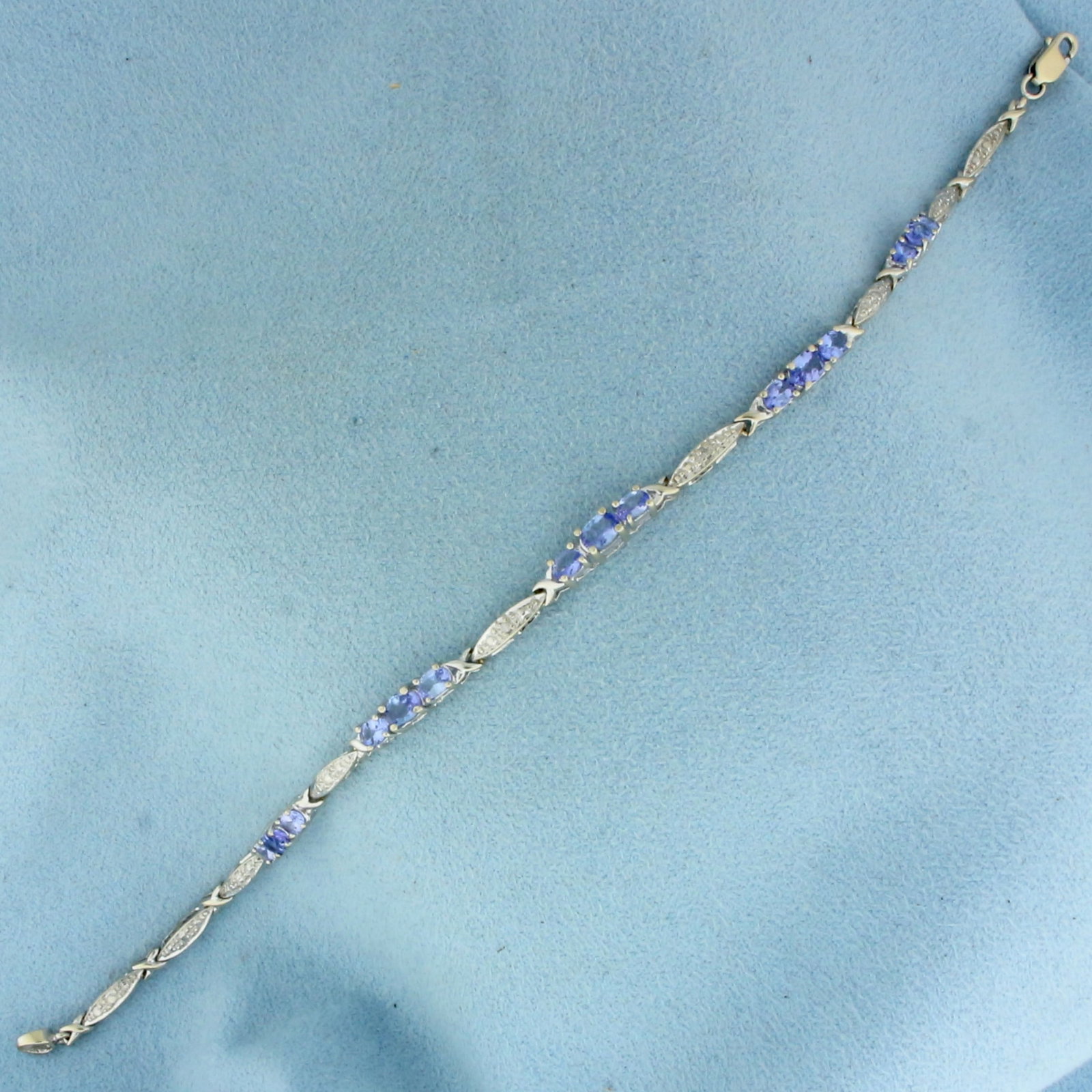 Tanzanite and Diamond Bracelet in 14k White Gold: In 14k White Gold. Contains five 3x4mm and ten 2.5x3.5mm high quality natural Tanzanite gemstones with bright color and excellent clarity. Also contains two 1/2pt high quality diamonds. 7 3/8 inches l