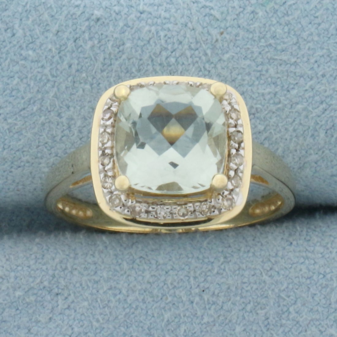 Prasiolite and Diamond Halo Ring in 14k Yellow Gold: In 14k Yellow Gold. Contains one 8mm high quality fancy checkerboard cushion cut natural Prasiolite gemstone, with bright color and excellent clarity. Also contains twenty-one high quality 1/2pt diamo