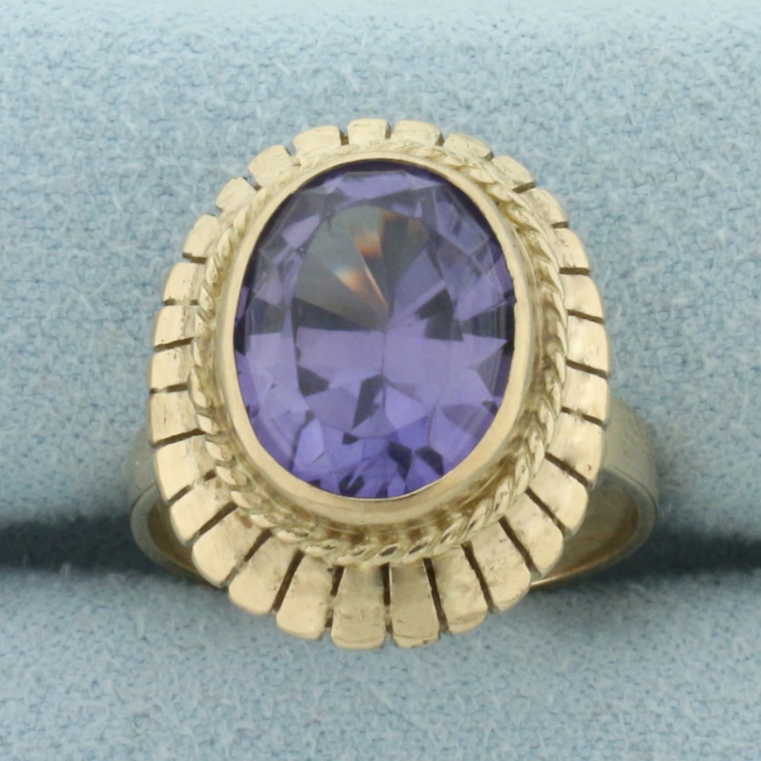 Color Changing Lab Alexandrite Solitaire Ring in 14k Yellow Gold: In 14k Yellow Gold. Contains one 12x10mm high quality oval Lab color changing Alexandrite gemstone, approximately 5cts, with dramatic color shift from blue/purple to pink. Size 6.5. 5.0g.