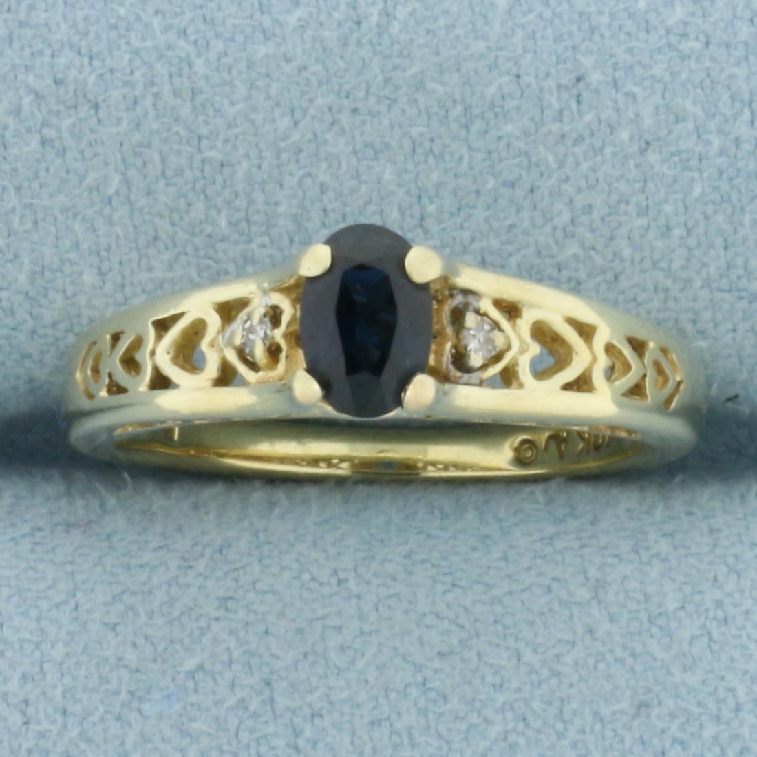 Sapphire and Diamond Heart Ring in 10k Yellow Gold: In 10k Yellow Gold. Contains one 4x6mm high quality oval cut natural Sapphire gemstone, approximately 1/2ct, with intense color and excellent clarity. Also contains two high quality 1/2pt diamonds. Si