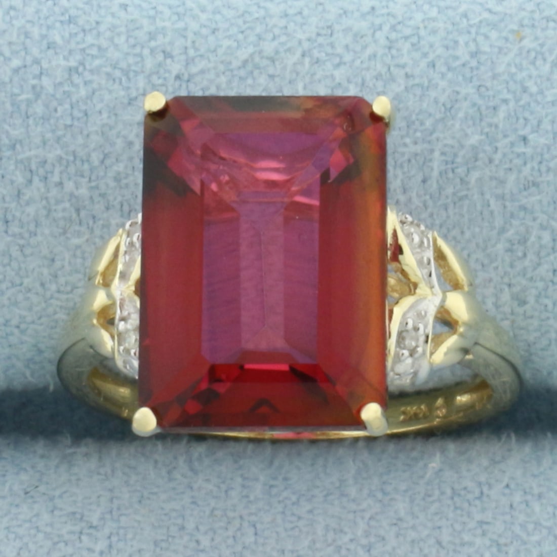 Rhodolite Garnet and Diamond Ring in 14k Yellow Gold: In 14k Yellow Gold. Contains one 14x10mm high quality emerald cut natural Rhodolite Garnet gemstone, approximately 6cts, with intense color and excellent clarity. Also contains four high quality 1/2pt