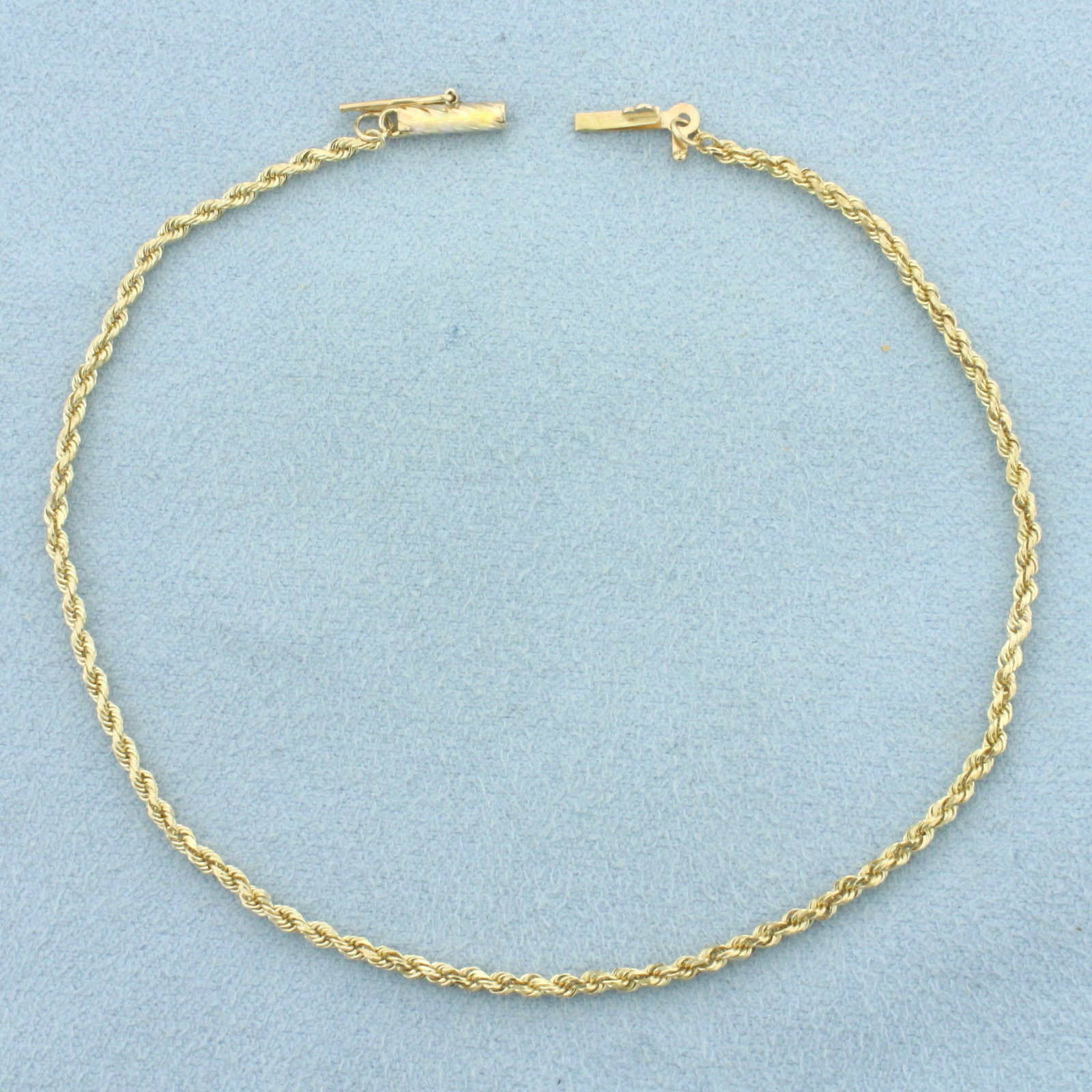Rope Link Bracelet in 14k Yellow Gold: In 14k Yellow Gold. 8 3/8 inches long. 1.6mm wide. Barrel clasp with safety latch. 2.5g.