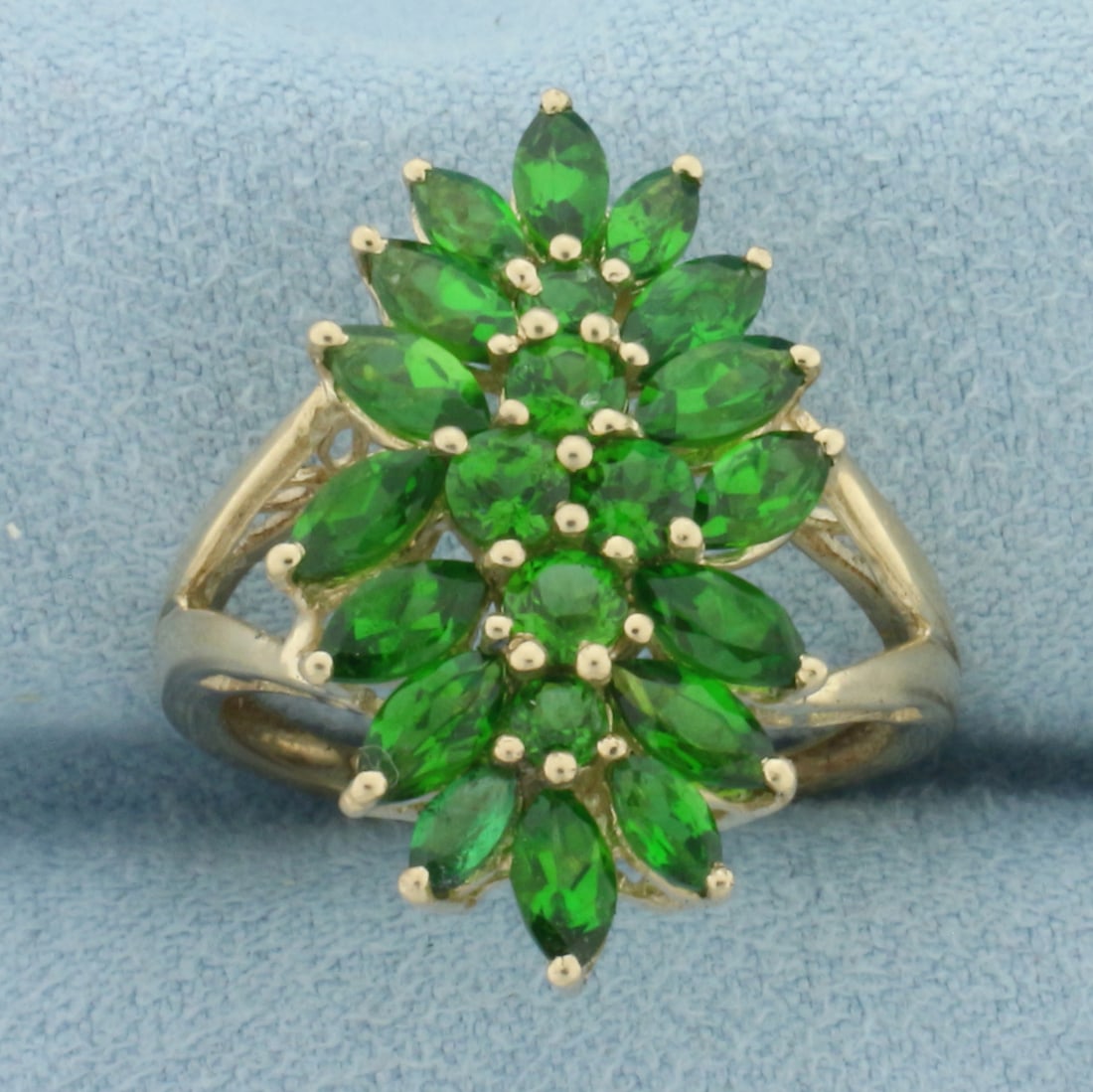 Green Garnet Ring in 10K Yellow Gold: In 10k yellow gold. 24mm wide at top center of ring. Contains 2ct TW of high quality natural round and marquise shaped Green Garnet gemstones with vibrant color and excellent clarity. Size 7.5. 3.7g.