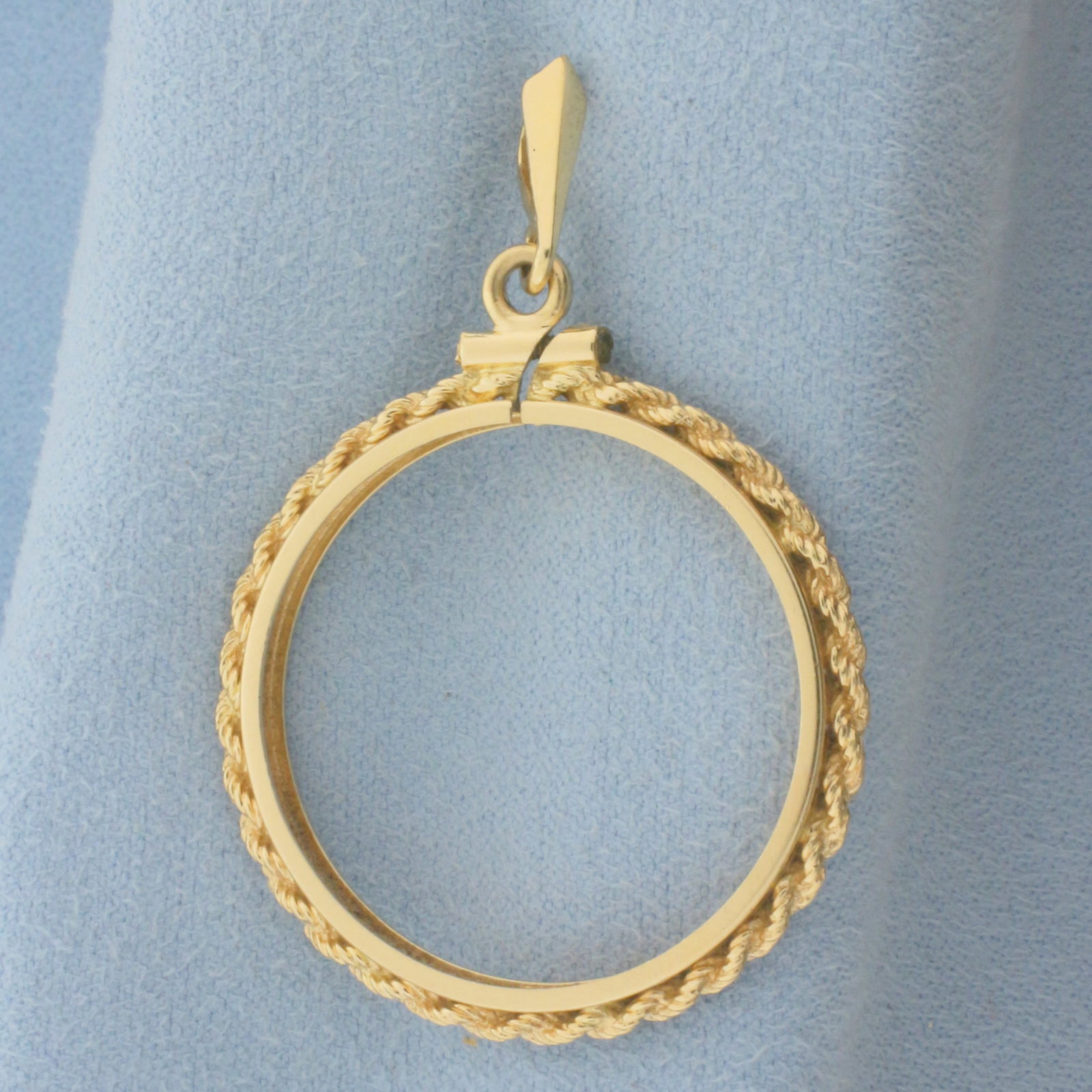 27mm 1/2oz Gold Eagle Coin Bezel Pendant in 14k Yellow Gold: In 14k Yellow Gold. 1 3/4 inch long (including bale). 1 1/8 inch wide. Fits any 27mm coin such as a 1/2oz Gold American Eagle or $10 Indian/Liberty Head. 4.8g.