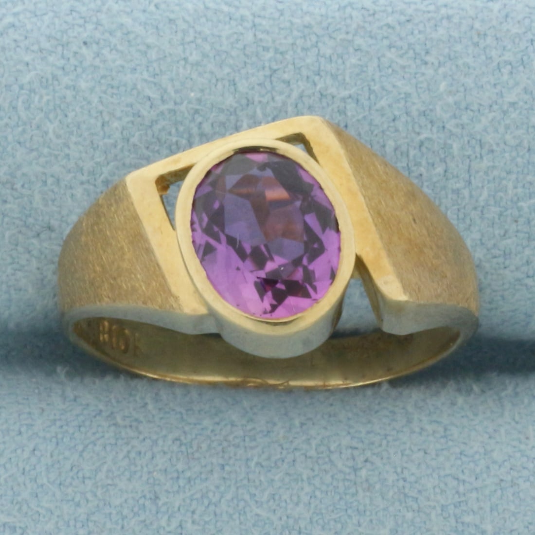 Amethyst Statement Ring in 10k Yellow Gold: In 10k Yellow Gold. Contains one 9x7mm high quality oval cut natural Amethyst gemstone, approximately 2cts, with vibrant color and excellent clarity. 12mm wide at top center. Size 10. 4.6g.