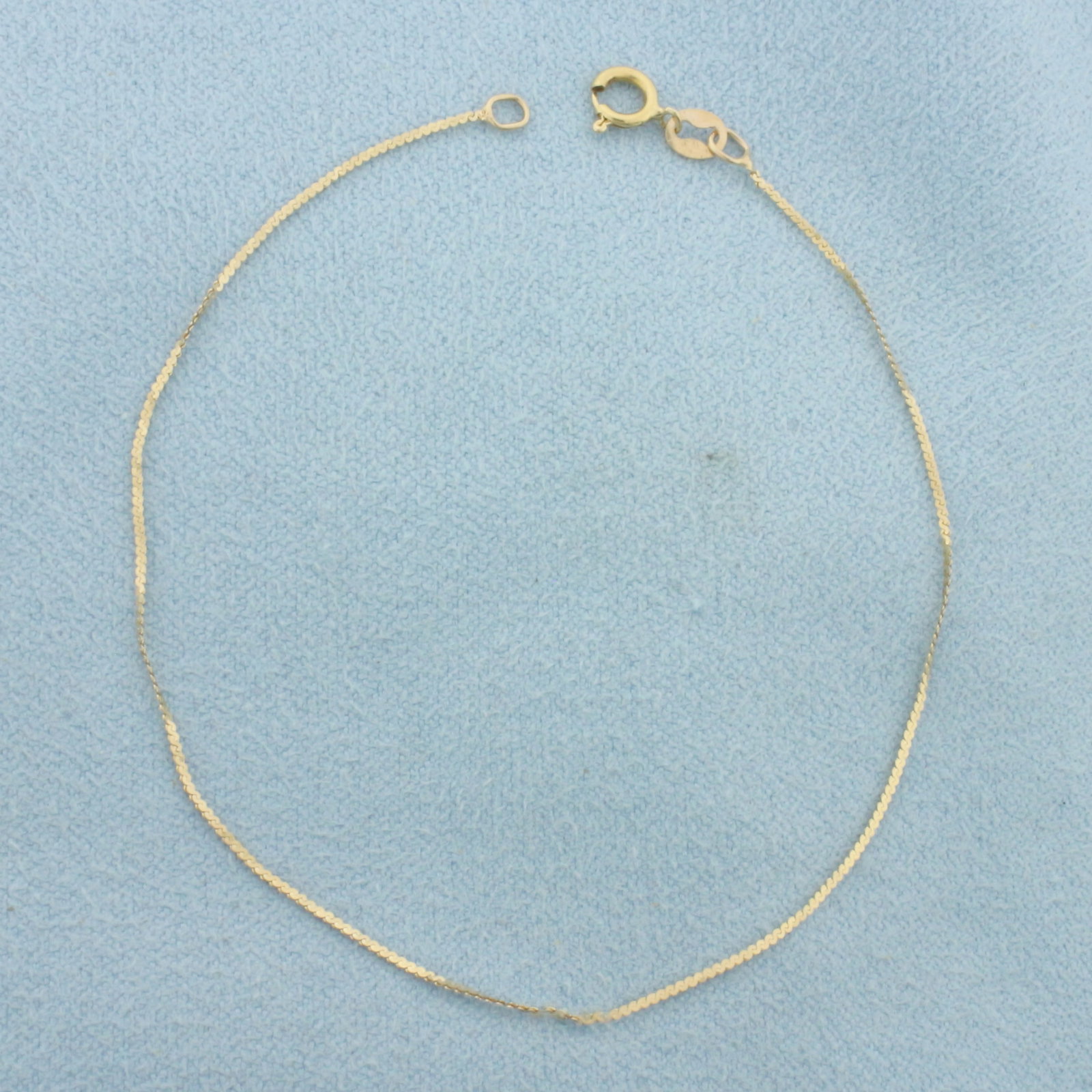 Italian S-Link Bracelet in 14k Yellow Gold: In 14k Yellow Gold. 6 3/4 inches long. 0.7mm wide. Italian made. Spring clasp. .4g.
