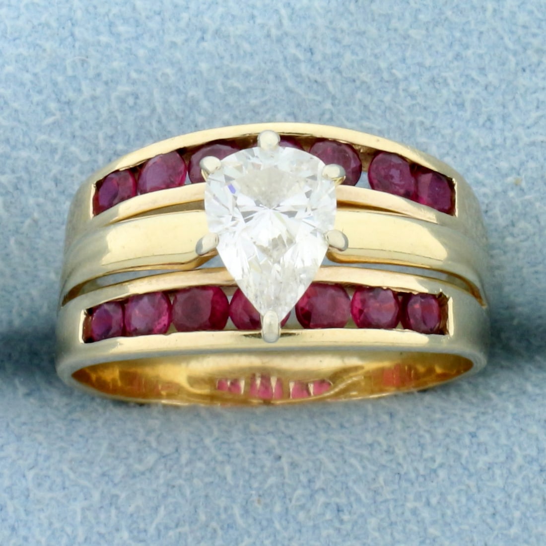 Vintage Pear Diamond and Ruby Ring in 14K Yellow Gold: In 14K Yellow Gold. Contains one high quality natural 1ct pear shaped Diamond, VS clarity/H color. Also contains fourteen high quality natural 2mm round cut Ruby gemstones with bright color and excell