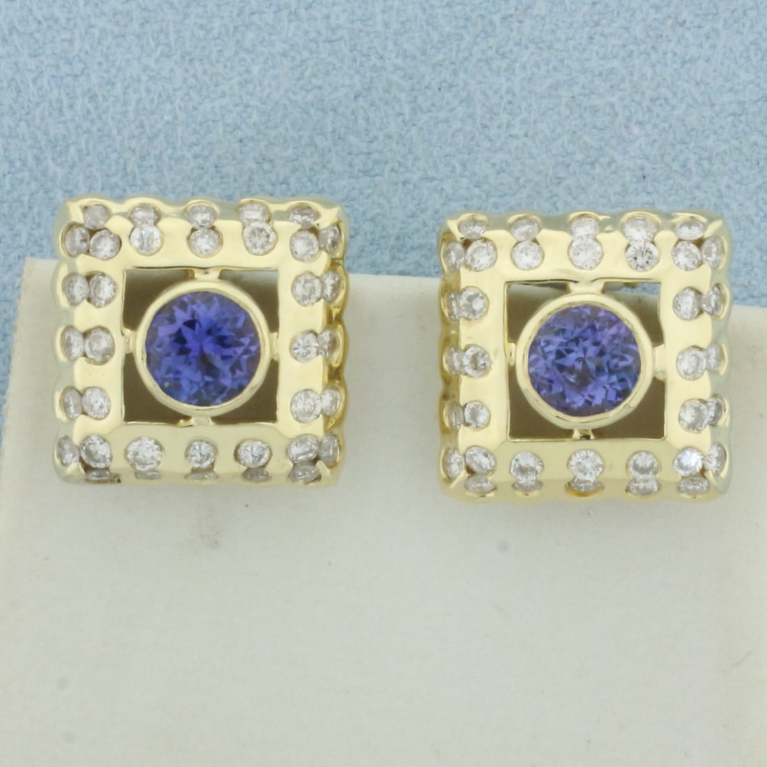 AAA Tanzanite and Diamond Earrings in 14k Yellow Gold: In 14k Yellow Gold. Contains two 3/4ct AAA quality natural Tanzanite gemstones, approximately with vivid color and excellent clarity. Also contains sixty .02ct high quality diamonds, SI clarity/H colo