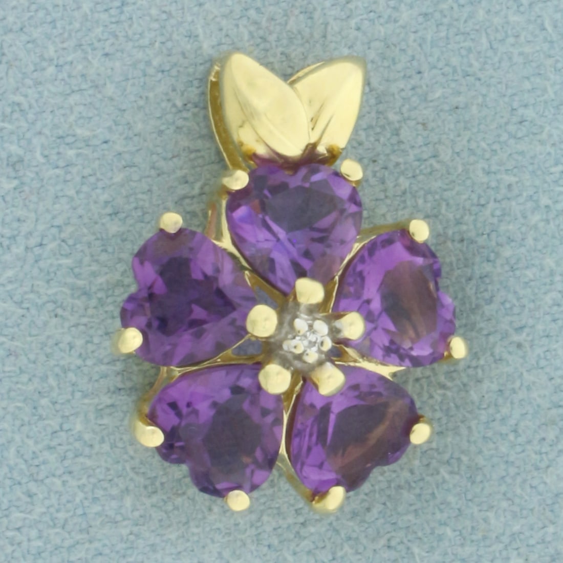 Heart Cut Amethyst and Diamond Clover Pendant in 14k Yellow Gold: In 14k Yellow Gold. Contains five 6mm high quality heart cut natural Amethyst gemstones with vibrant color and excellent clarity. Also contains one .01ct high quality diamond. 3/4 inch long. 5/8 inch 