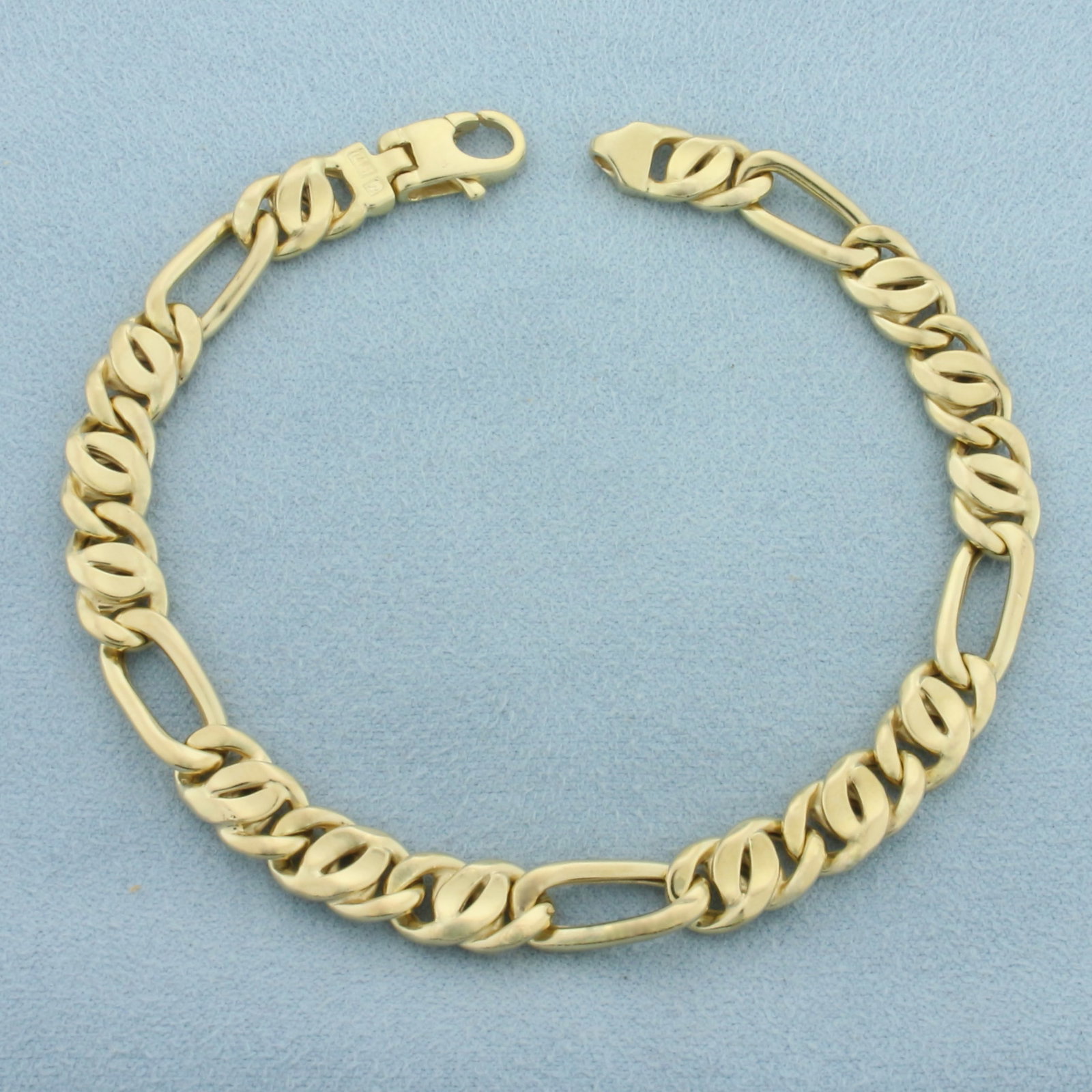 Mens Figaro Link Bracelet in 14k Yellow Gold: In 14k Yellow Gold. 8 1/2 inches long. 6.8mm wide. Lobster clasp. 14.3g.