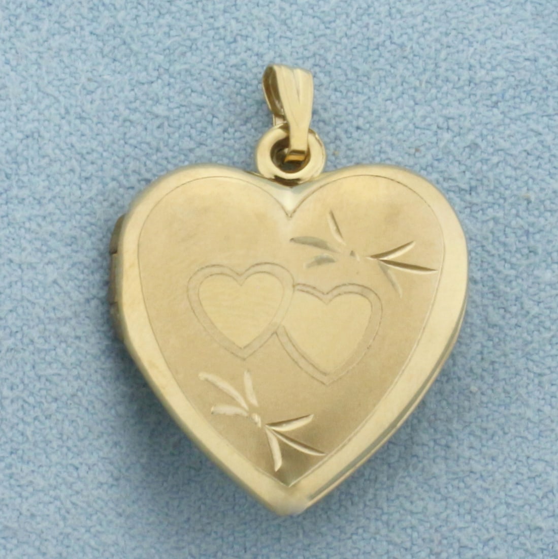 Vintage Heart Locket Pendant in 10k Yellow Gold: In 10k Yellow Gold. 7/8 inch long. 3/4 inch wide. Opens to 1 3/8 inch wide. 2.4g.