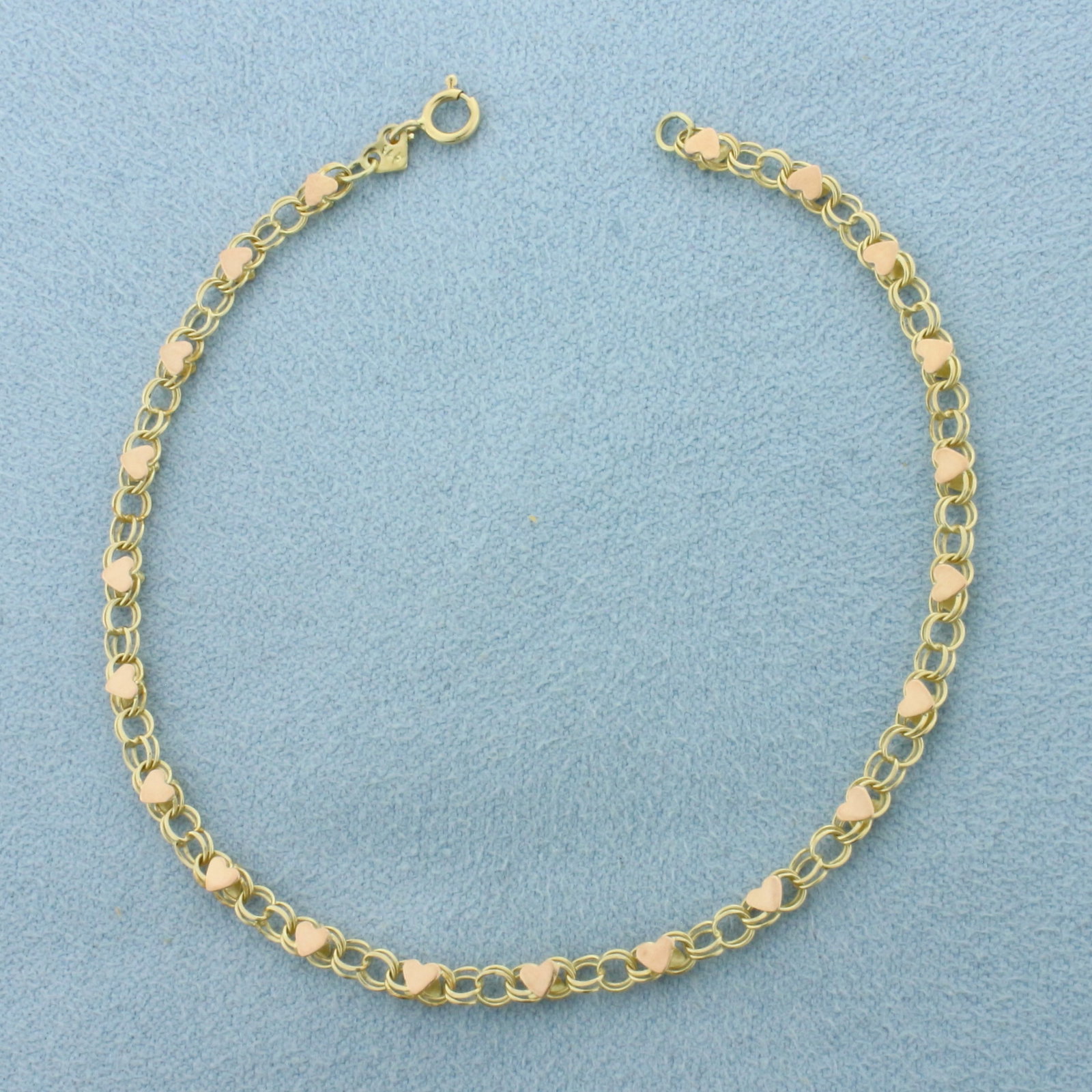 Heart Link Bracelet in 14k Yellow and Rose Gold: In 14k Yellow Gold with Rose Gold Hearts. 7 inches long. 2.9mm wide. Spring clasp. 2.0g.