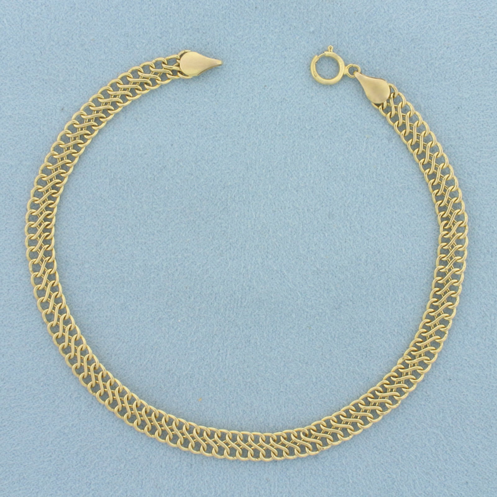 Infinity Link Bracelet in 14k Yellow Gold: In 14k Yellow Gold. 8 1/8 inches long. 5.3mm wide. Spring clasp. 2.2g.