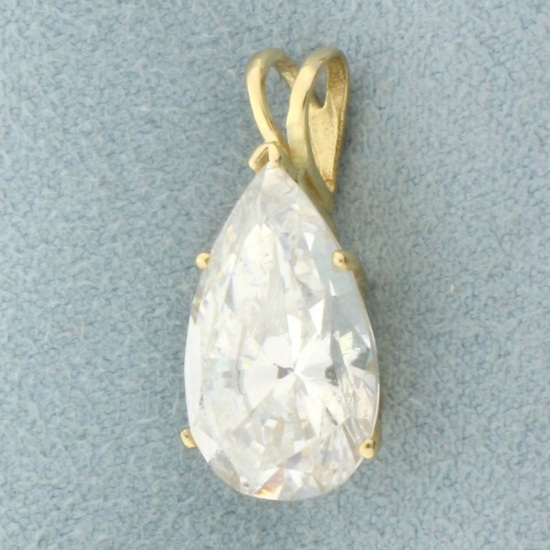 Large Pear Cut CZ Pendant in 14k Yellow Gold: In 14k Yellow Gold. Contains one 16x10mm high quality Cubic Zirconia gemstone, approximately 8cts, with excellent cut and clarity for added brilliance. 7/8 inch long. 3/8 inch wide.