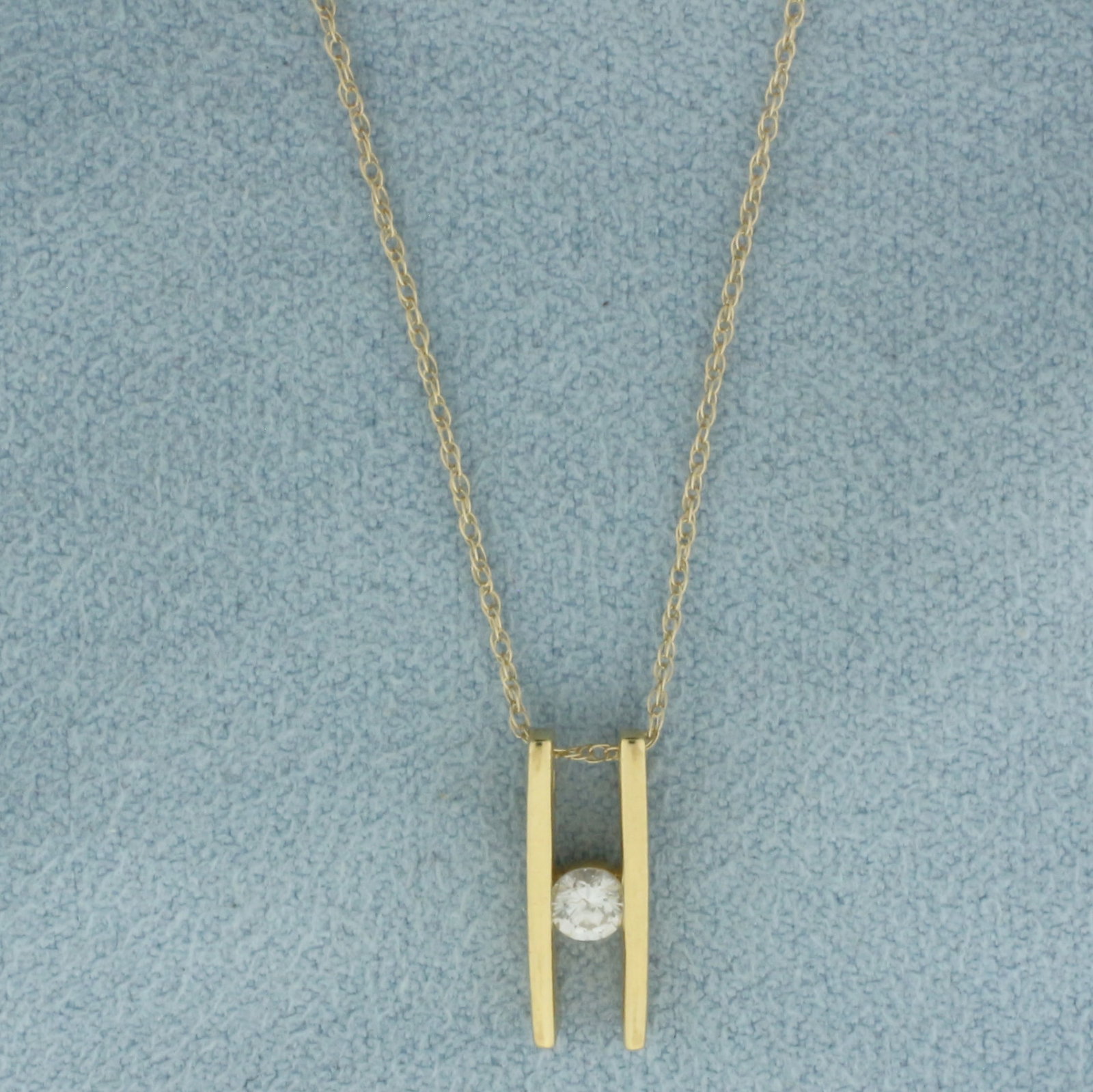 Diamond Bar Pendant Necklace in 14k Yellow Gold: In 14k Yellow Gold. Contains one .10ct high quality round brilliant diamond, SI clarity/H color. Pendant is 1/2 inch by 1/4 inch. Chain is 18 inches long, 0.6mm wide. Spring clasp. 1.3g.