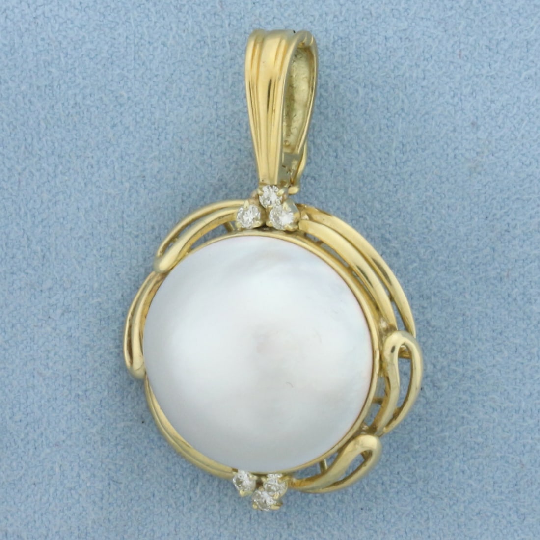 Large Mabe Pearl and Diamond Statement Pendant in 18K Yellow Gold: In 18K Yellow Gold. Contains a high quality natural 19.5mm Mabe Peal with excellent luster and a beautiful white silver color. Also contains six high quality .03ct Diamonds, VS clarity/H color. 1 1/2 
