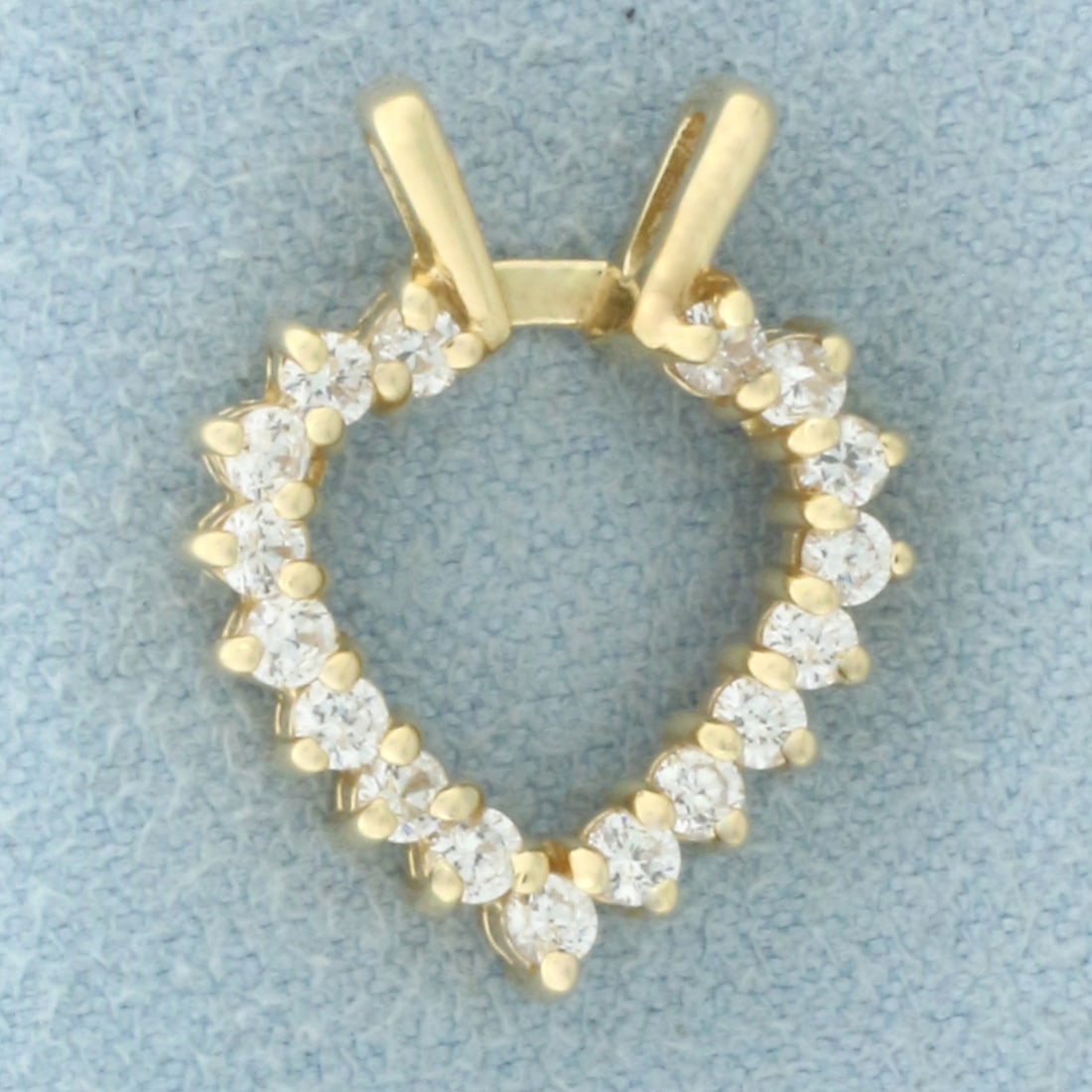 Diamond Heart Pendant in 14k Yellow Gold: In 14k Yellow Gold. Contains seventeen high quality diamonds, 1/2ct TW, SI1 clarity/H color. 3/4 inch long. 5/8 inch wide. 2.2g.
