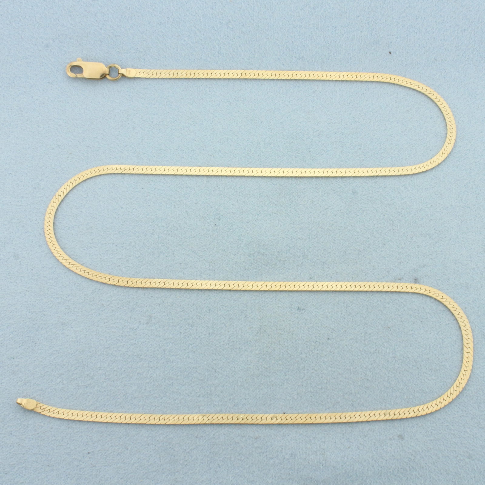 18 Inch Herringbone Chain Link Necklace in 14k Yellow Gold: In 14k Yellow Gold. 18 inches long. 2.3mm wide. Lobster clasp. 5.4g.