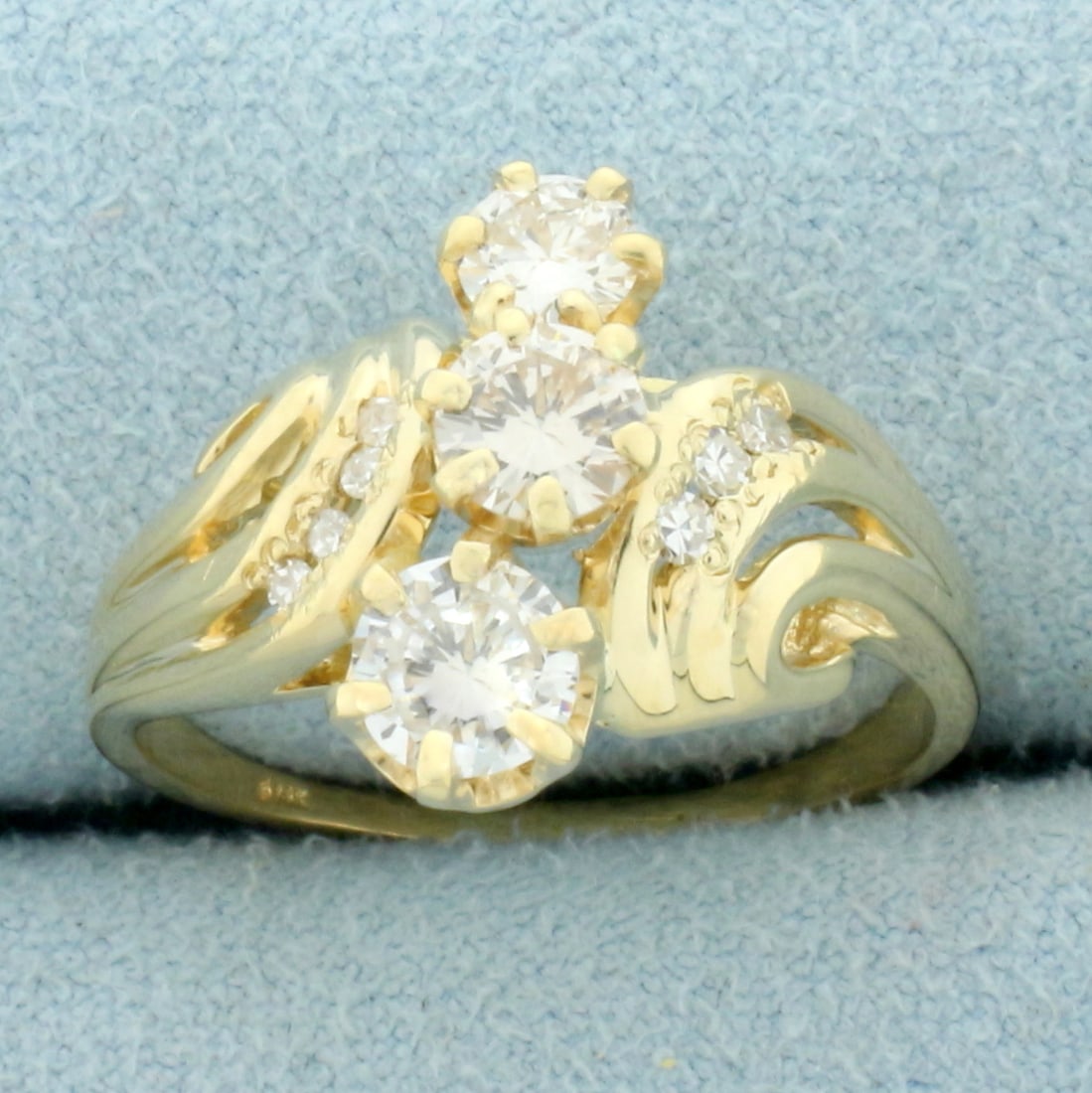 Designer Three Stone Diamond Wedding or Anniversary Ring in 14K Yellow Gold: In 14K Yellow Gold. Contains one .4ct, one .3ct, one .25ct and six .01ct high quality diamonds, VVS clarity/F color, great cut for lots of sparkle. Size 7 1/2. 4.2g.
