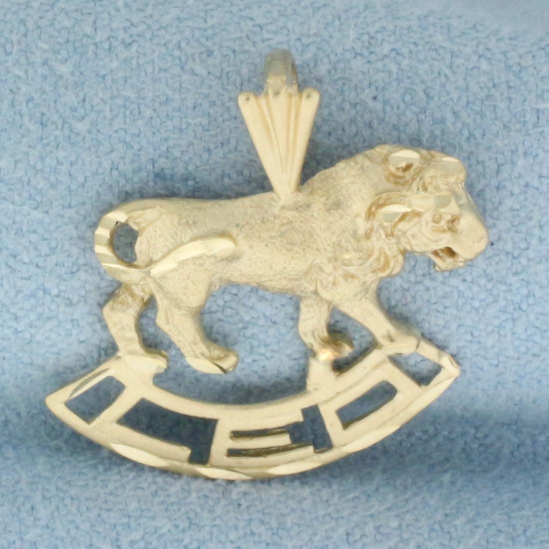 Zodiac Leo Lion Pendant in 14k Yellow Gold: In 14k Yellow Gold. 7/8 inch long. 3/4 inch wide. 1.8g.