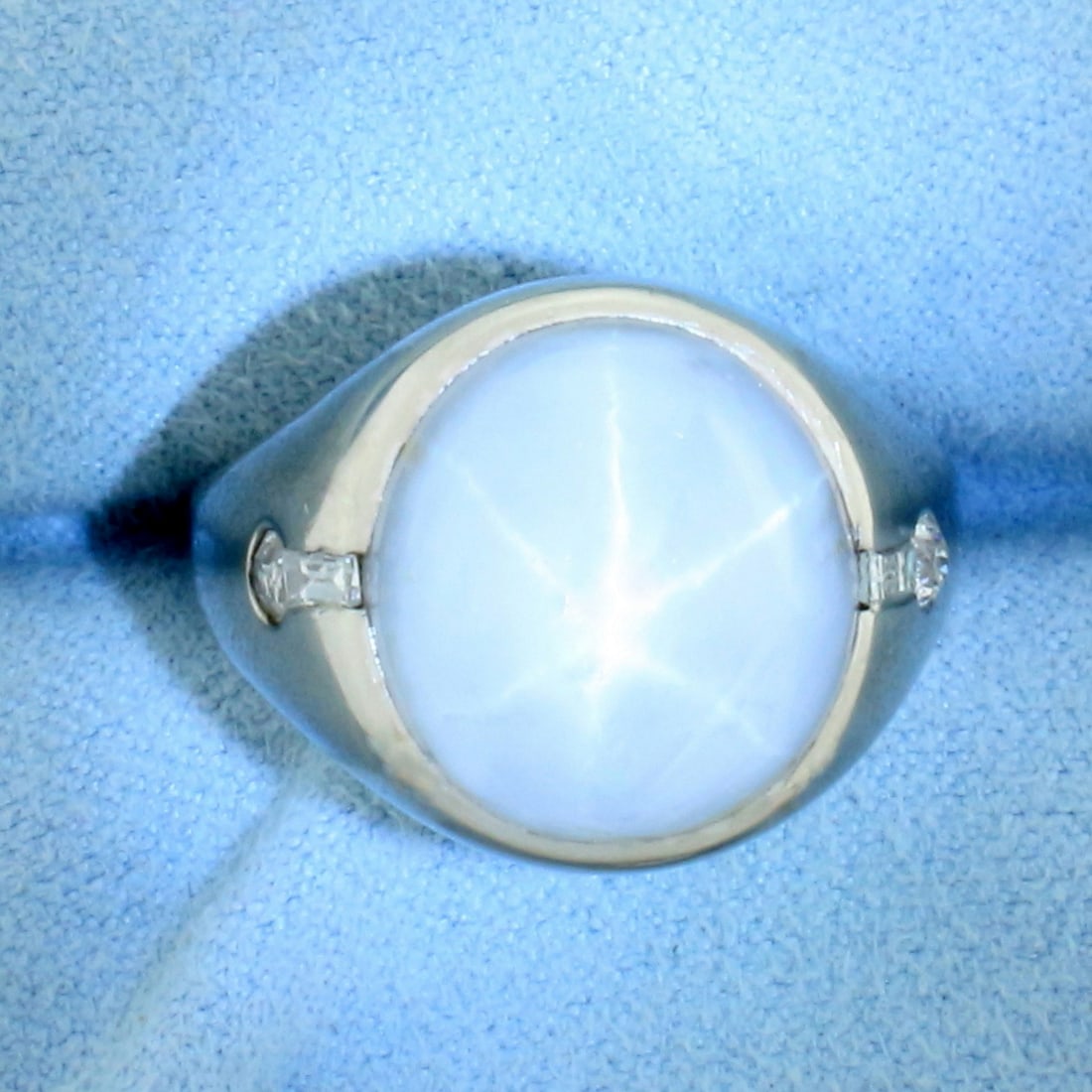 Mens Natural Star Sapphire and Diamond Ring in 18k White Gold: In 18k White Gold. Contains one high quality natural 14mm Star Sapphire gemstone with distinct "star" under light. Also contains two 1/10ct old European cut and two 3mm baguette high quality diamonds,