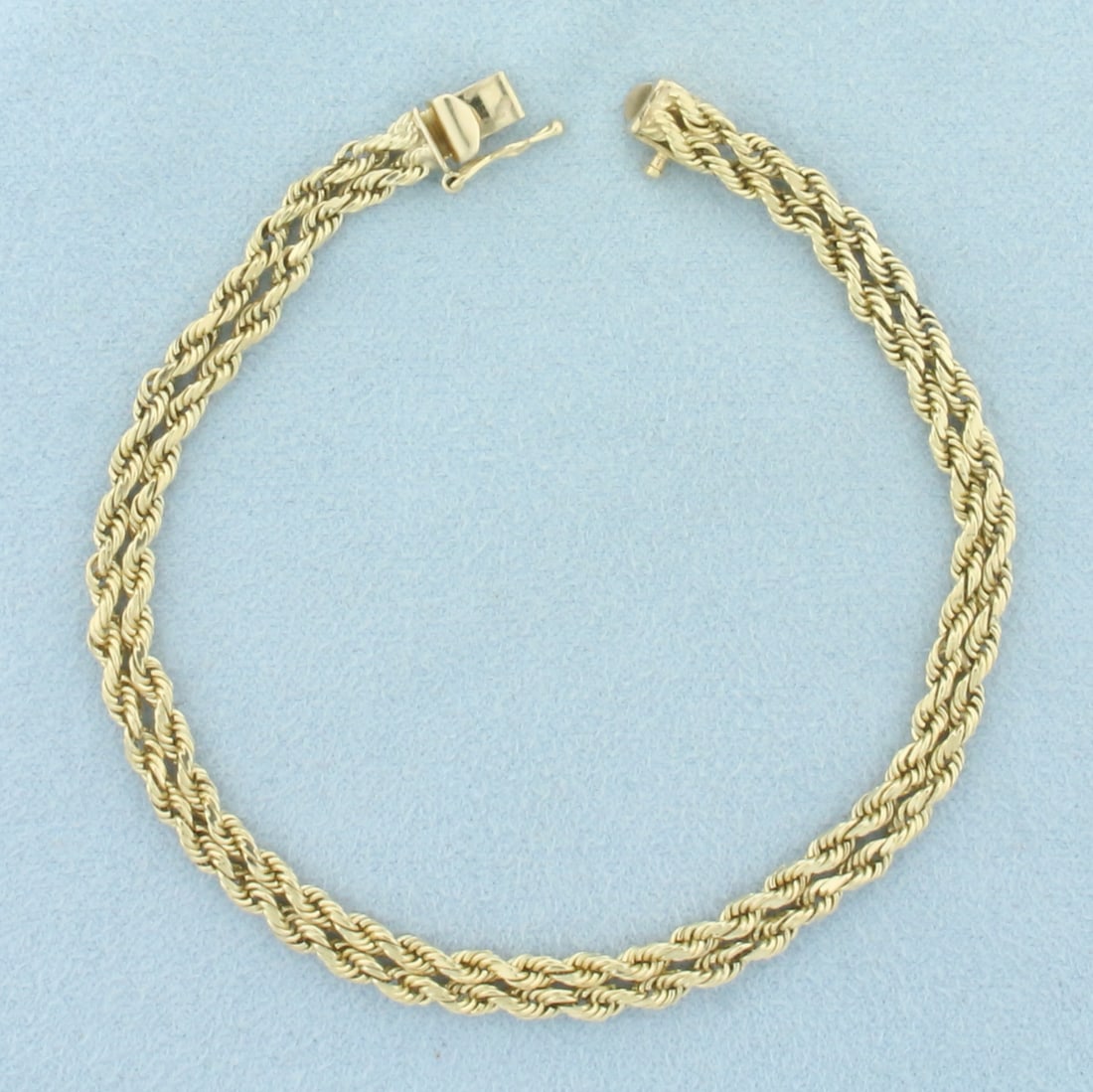 Double Rope Bracelet in 14k Yellow Gold: In 14k Yellow Gold. 7 5/8 inches long. 5mm wide. Slide clasp with safety latch. 10.1g.