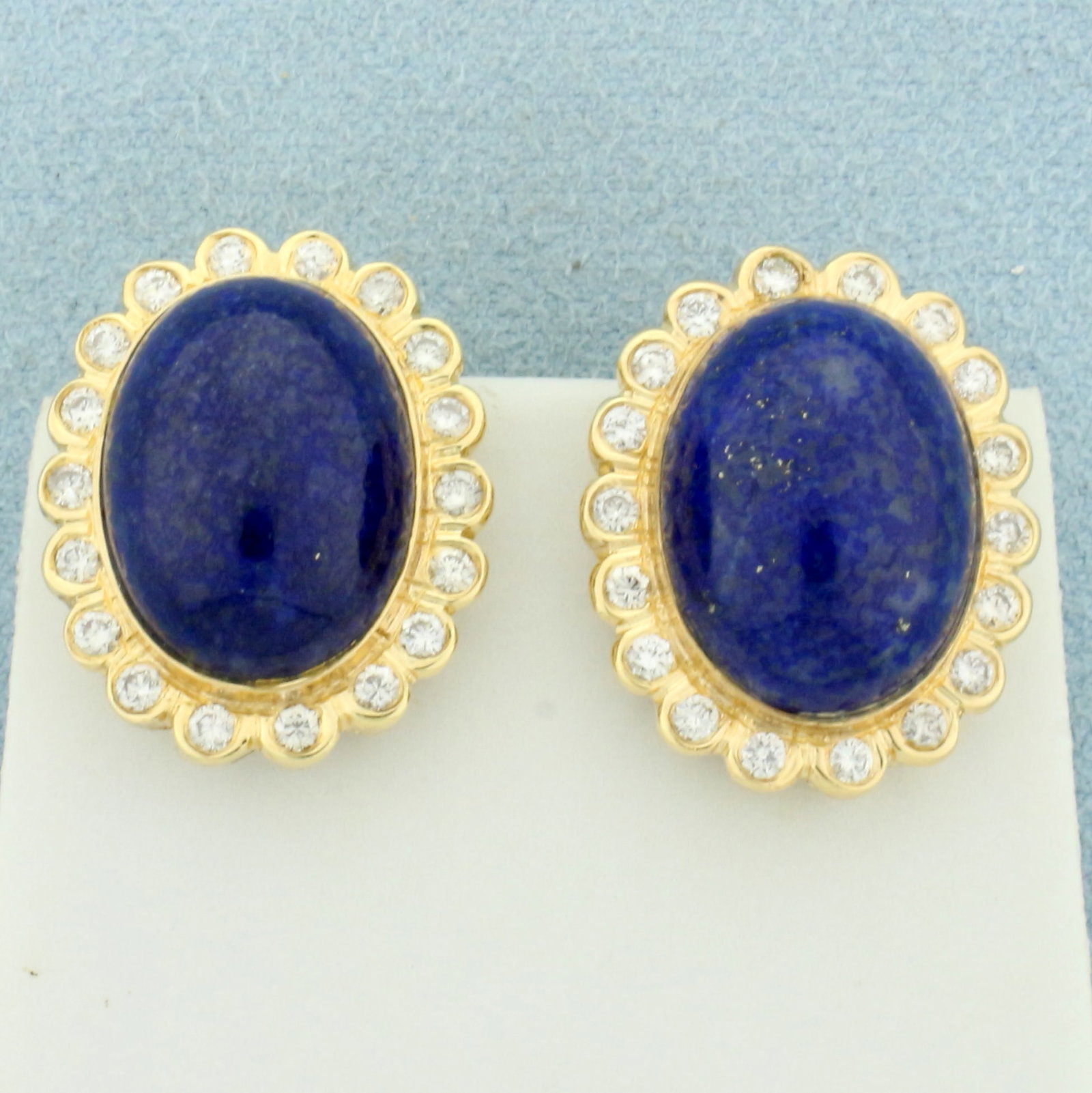 Lapis Lazuli And Diamond Halo Earrings in 14k Yellow Gold: In 14k yellow gold. Contains two 16mm x 12mm high quality Cabochon cut Lapis Lazuli gemstones with deep blue color and gold fleks. Also contains thirty six high quality diamonds,1ct TW, VS clarity/H c