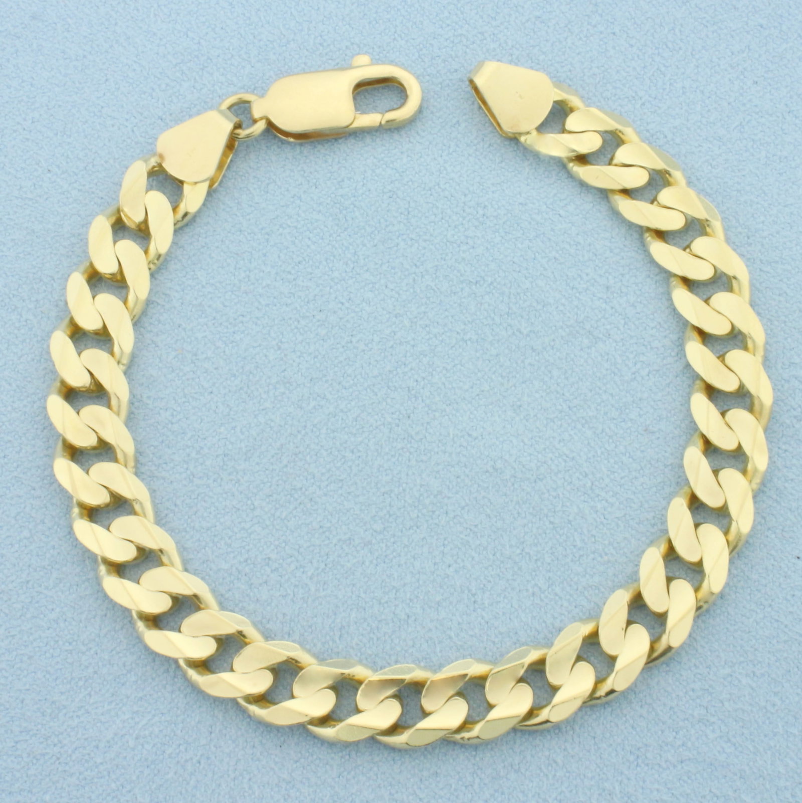 Italian Curb Link Bracelet in 14k Yellow Gold: In 14k Yellow Gold. 7 1/8 inches long. 7.4mm wide. Italian made. Lobster clasp. 18.9g.