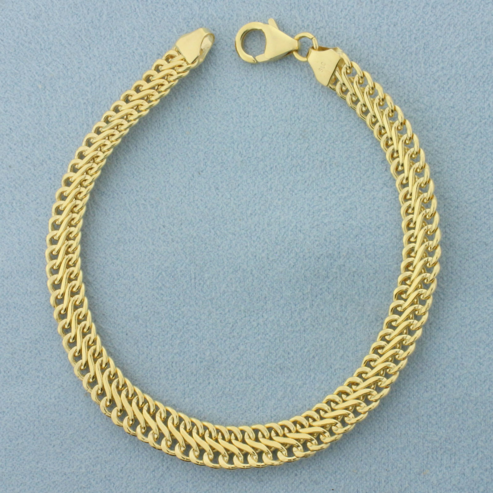 Italian Infinity Link Bracelet in 14k Yellow Gold: In 14k Yellow Gold. 7 inches long. 6.4mm wide. Italian made. Lobster clasp. 4.2g.