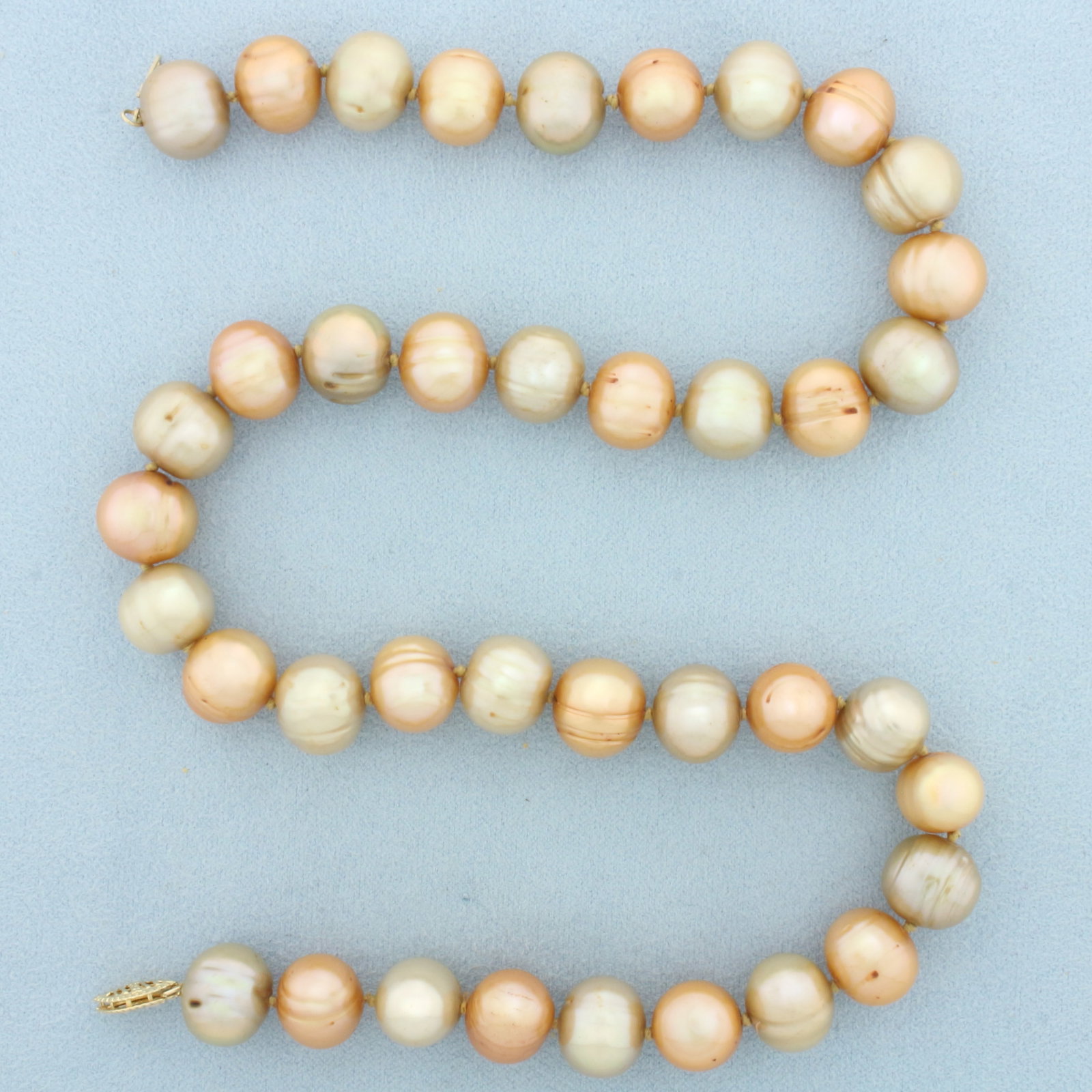 Baroque South Sea Pearl Necklace in 14k Yellow Gold: In 14k Yellow Gold. 18 inches long. Contains thirty nine 12mm high quality South Sea Pearls with high luster. Hand knotted. Decorative filigree clasp. 77.9g.