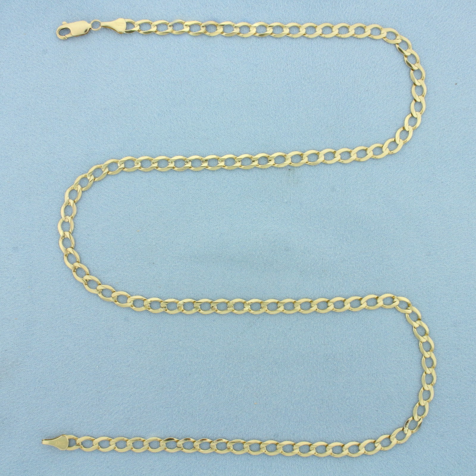 21 Inch Curb Link Chain Necklace in 10k Yellow Gold: In 10k Yellow Gold. 21 inches long. 5mm wide. Lobster clasp. 10.3g.