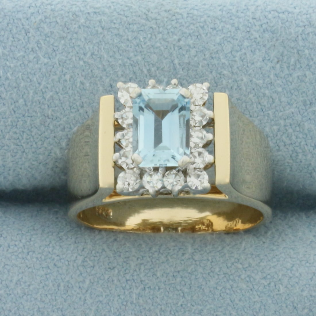 Aquamarine and Diamond Ring in 14k Yellow Gold: In 14k Yellow Gold. Contains one 7x5mm high quality emerald cut natural Aquamarine gemstone with bright color and excellent clarity. Also contains fourteen high quality diamonds, 1/2ct TW, VS