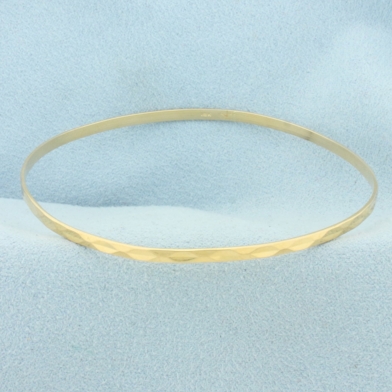 Beveled Design Bangle Bracelet in 18k Yellow Gold: In 18k Yellow Gold. 2 1/2 inch interior diameter. 2.3mm wide. 5.3g.