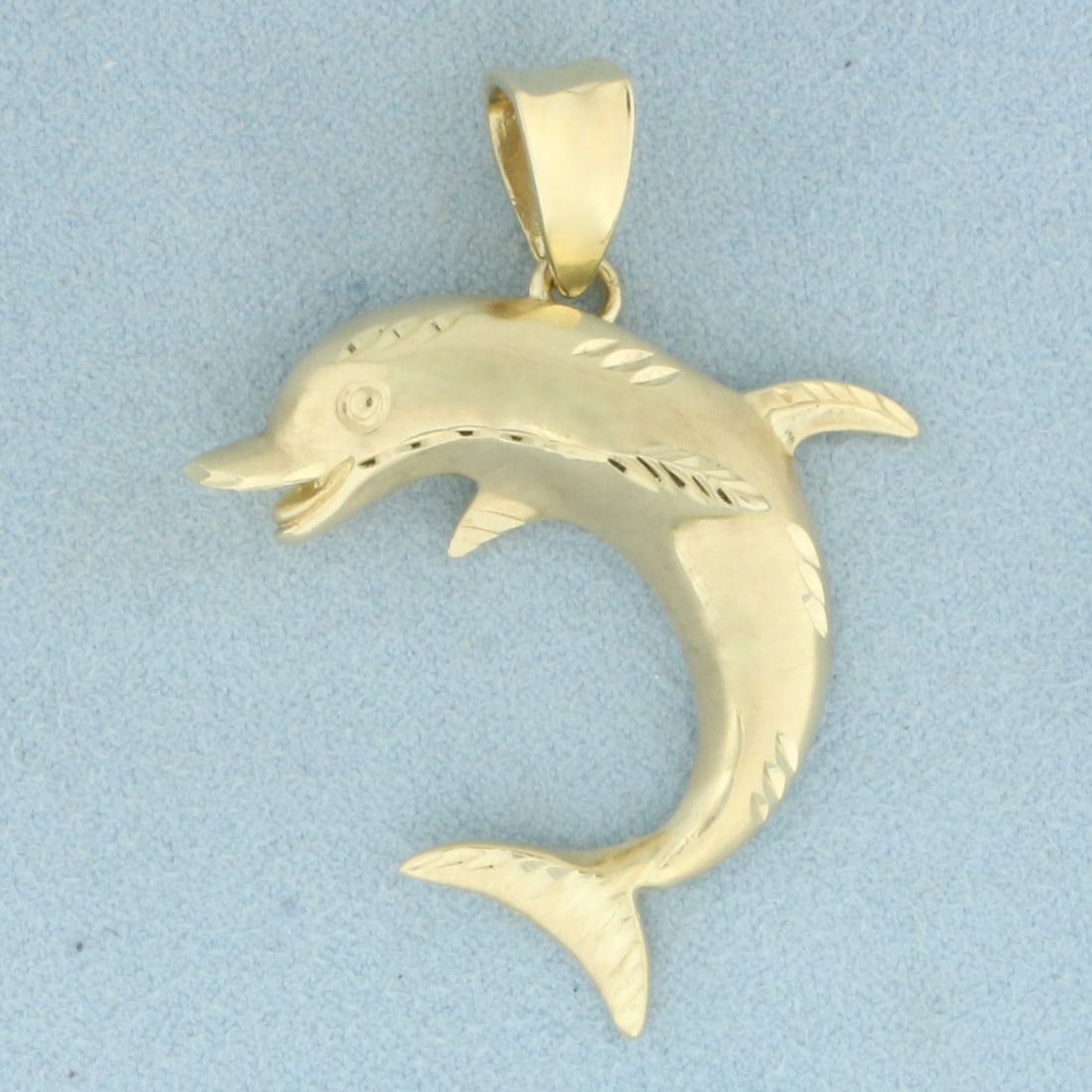 Large Dolphin Pendant in 14k Yellow Gold: In 14k Yellow Gold. 1 3/4 inch long including bail. 1 3/8 inch wide. Diamond cutting detail for added detail. 9.9g.