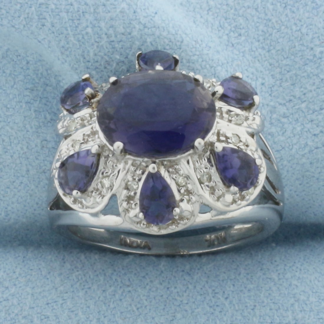 Tanzanite and Diamond Statement Ring in 10k White Gold: In 10k white gold. 17mm wide at top of ring. Contains one 10mm oval and six 6mm pear high quality natural Tanzanite gemstones with intense color and excellent clarity. Accented with eighteen high qual