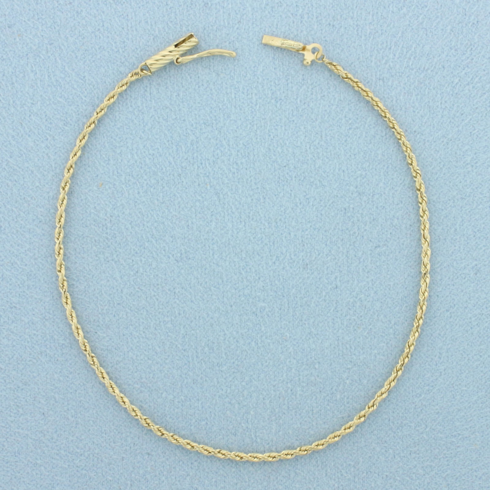 Rope Link Bracelet in 14k Yellow Gold: In 14k Yellow Gold. 7 inches long. 1.4mm wide. Barrel clasp with safety latch. 1.7g.