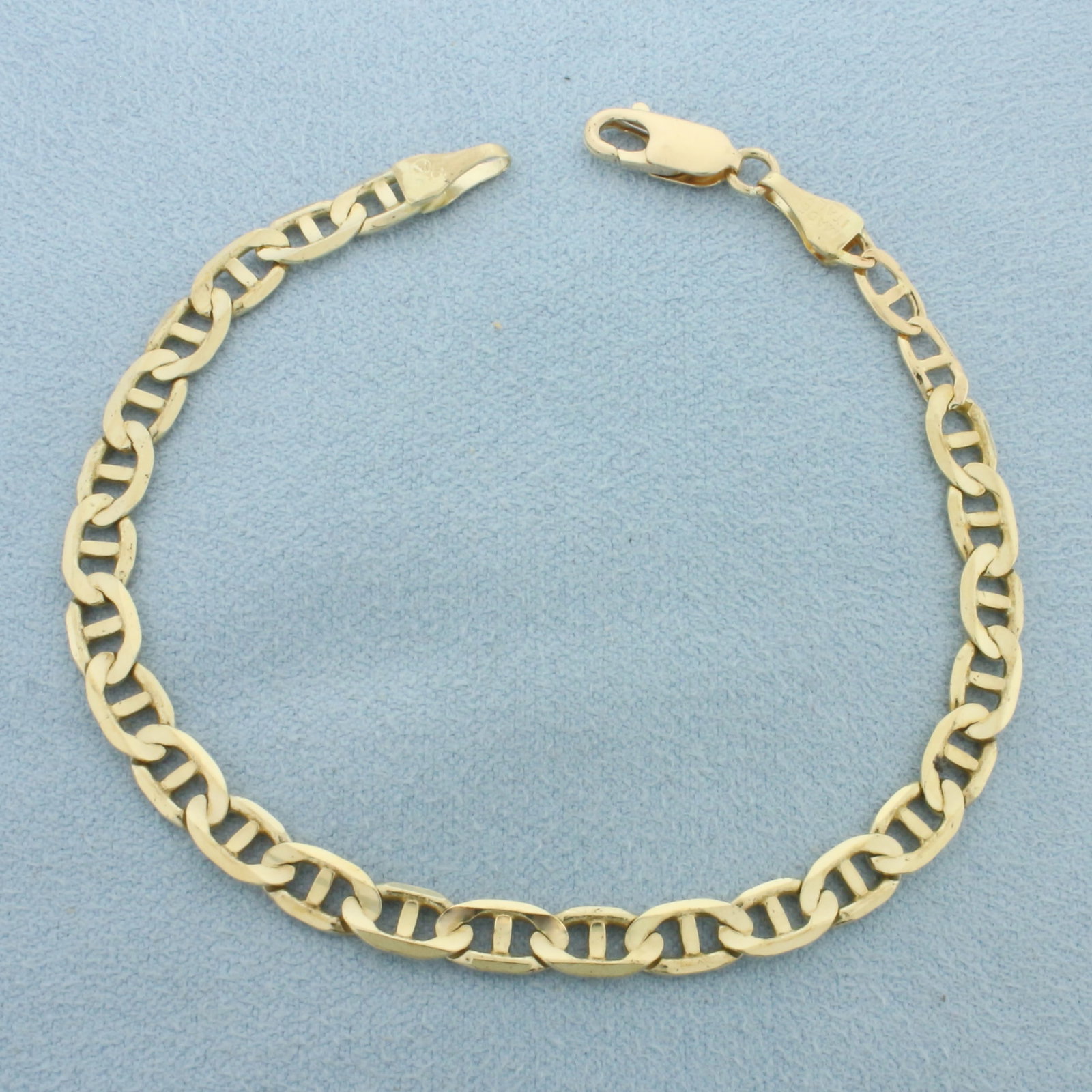 Italian Anchor Mariner Link Bracelet in 10k Yellow Gold: In 14k Yellow Gold. 7 1/4 inches long. 4.8mm wide. Italian made. Lobster clasp. 5.7g.