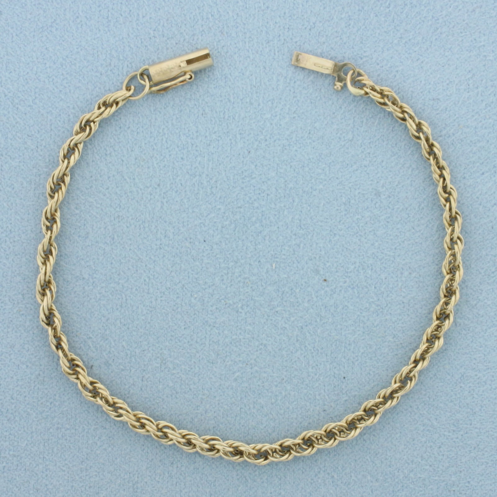 Rope Link Bracelet in 14k Yellow Gold: In 14k Yellow Gold. 6 3/4 inches long. 3.1mm wide. Barrel clasp with safety latch. 2.1g.