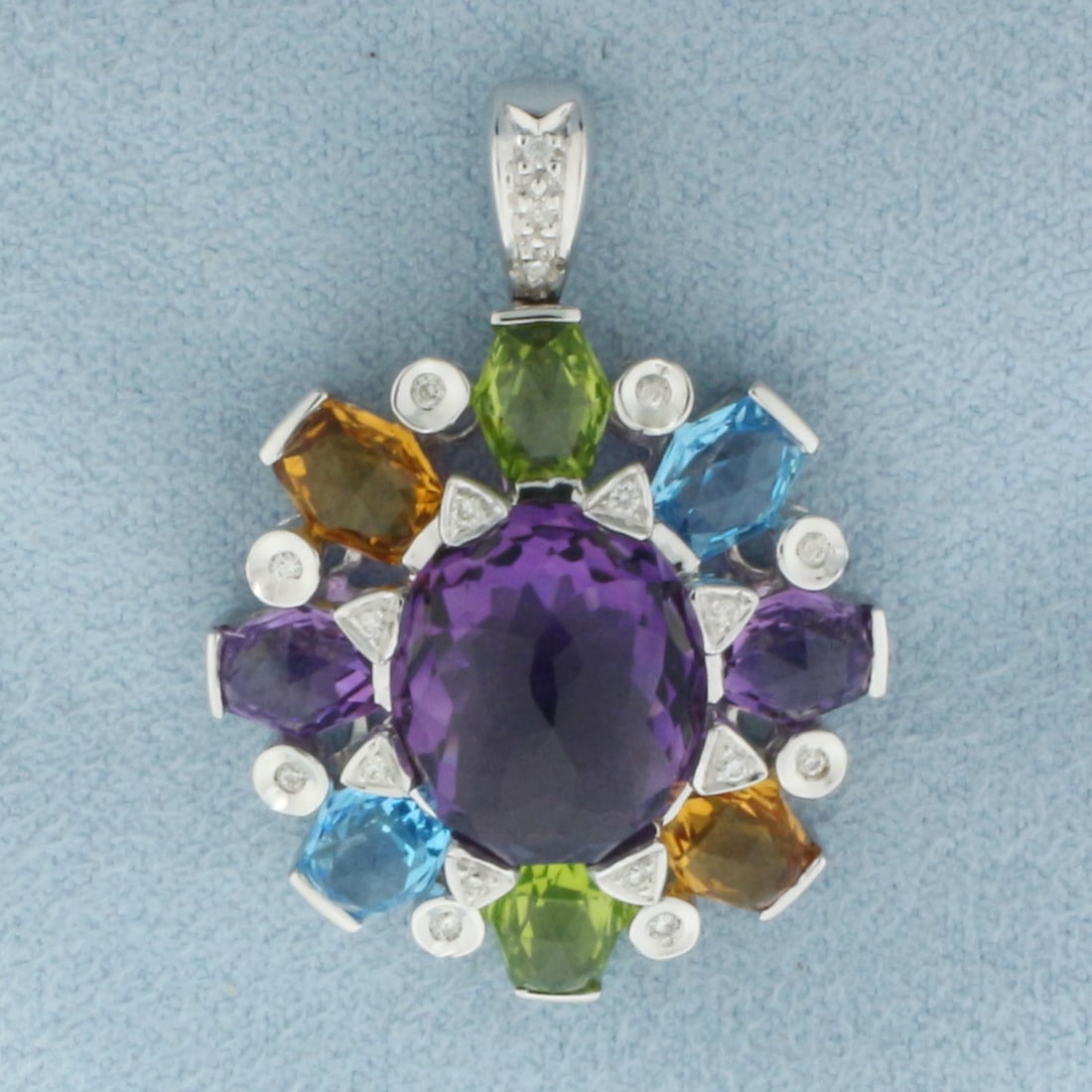 Rainbow Gemstone and Diamond Statement Pendant in 18k White Gold: In 18k White Gold. Contains one 13mm high quality fancy oval natural Amethyst gemstone with intense color and excellent clarity. Also contains eight 6mm high quality Peridot, Blue Topaz, Amethyst, and