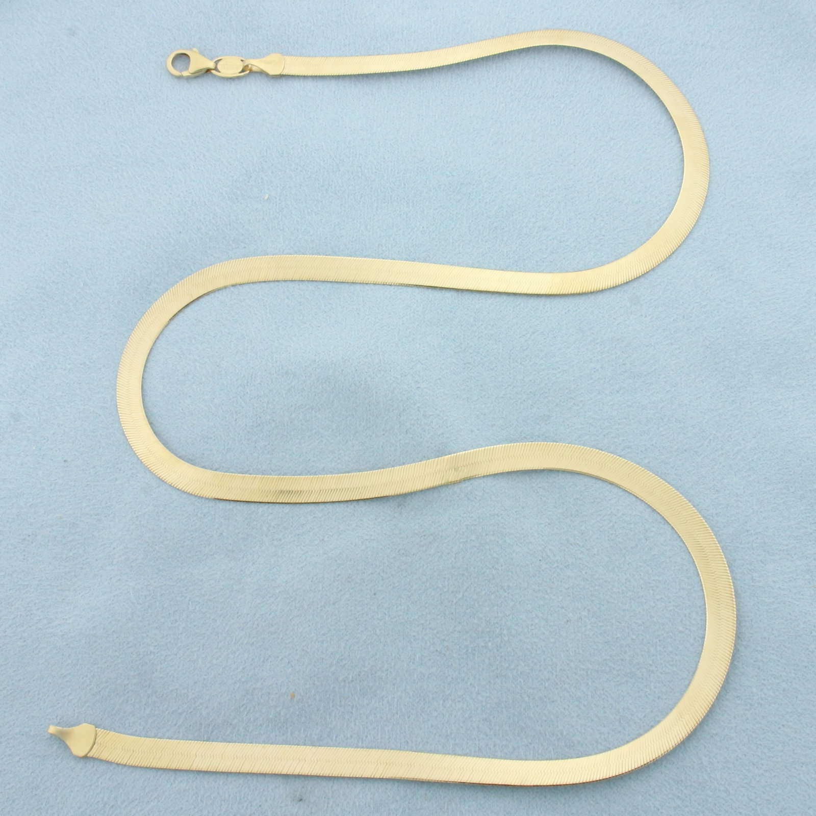 20 Inch Italian Herringbone Chain Necklace in 14k Yellow Gold: In 14k Yellow Gold. 20 inches long. 4.8mm wide. Italian made. Lobster clasp. 9.6g.