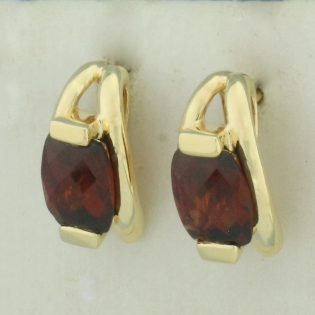 Checkerboard Garnet Earrings in 14K Yellow Gold: In 14k Yellow Gold. 1/2 inch long. 1/4 inch wide (profile). Contains two high quality natural 9mm elongated checkerboard cushion cut Garnet gemstones with intense color and excellent clarity. Friction