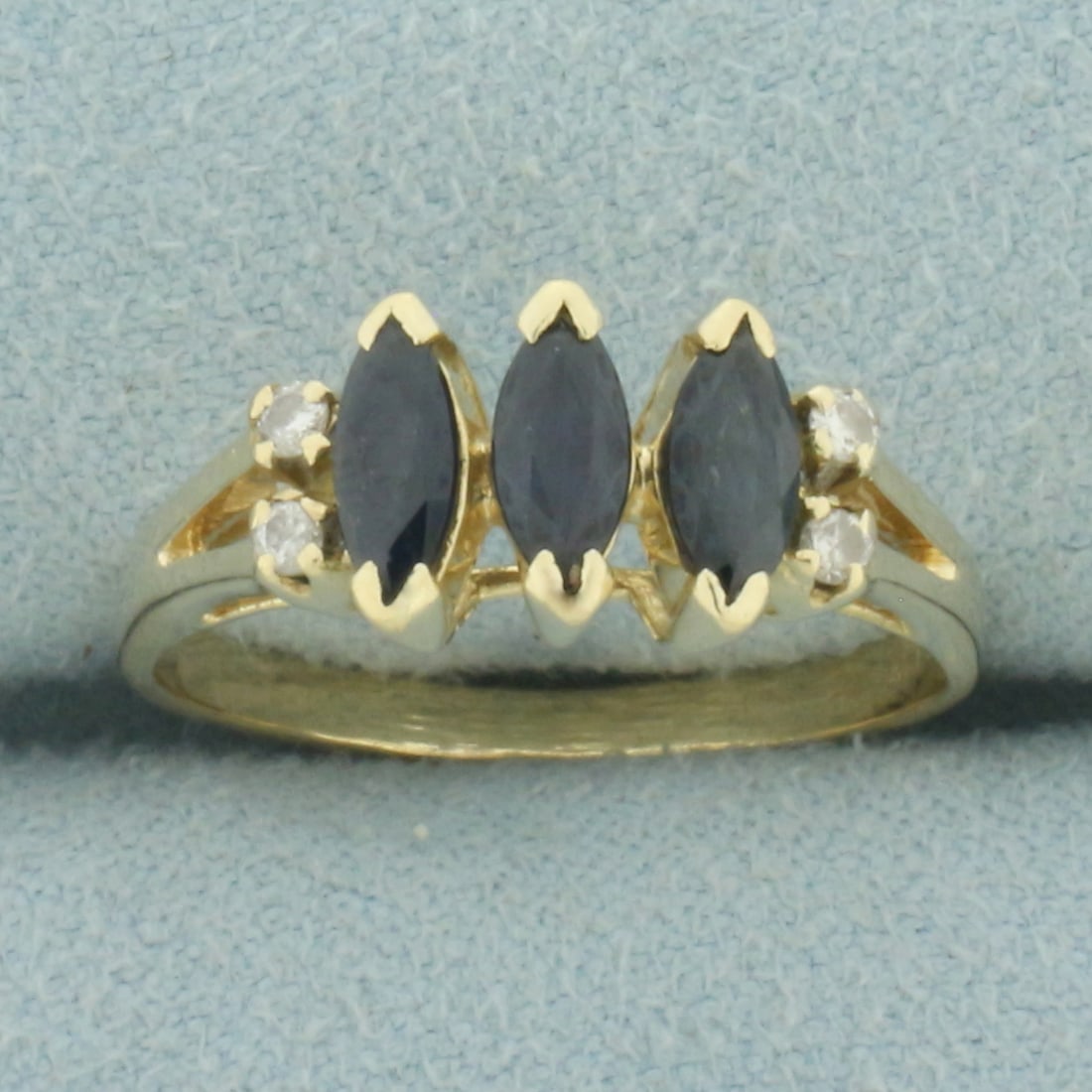 Sapphire and Diamond Ring in 14k Yellow Gold: In 14k yellow gold. Contains three high quality natural 6mm by 3mm marquise Sapphire gemstones with intense blue color and excellent clarity. Also contains four high quality .01ct diamonds, SI clarity